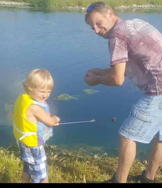 A man and child by water