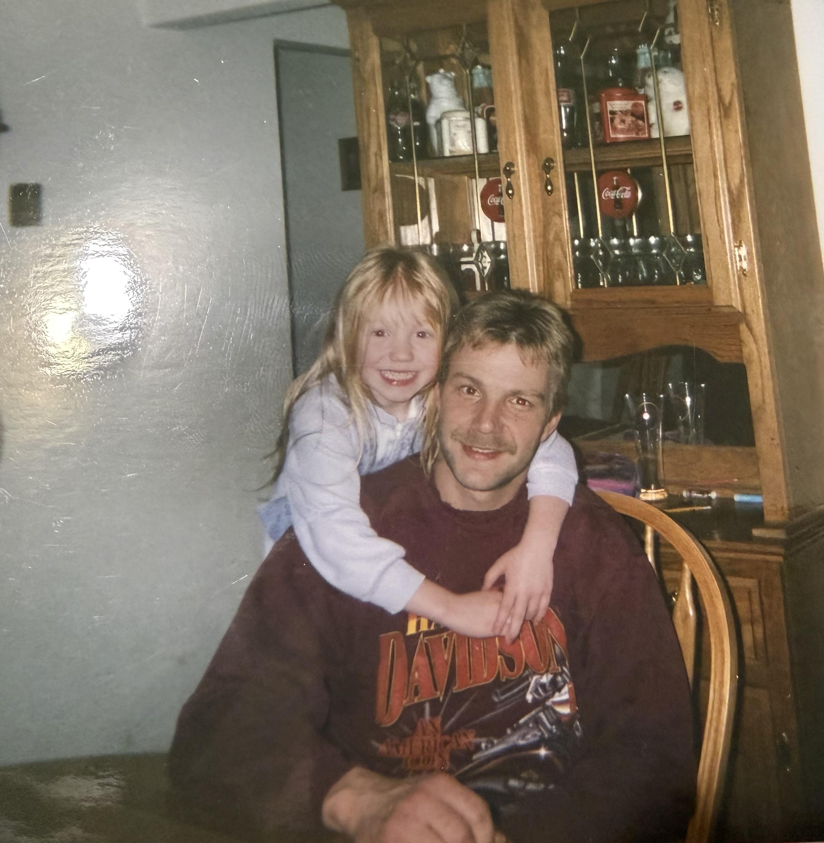 A man and a girl posing for a picture