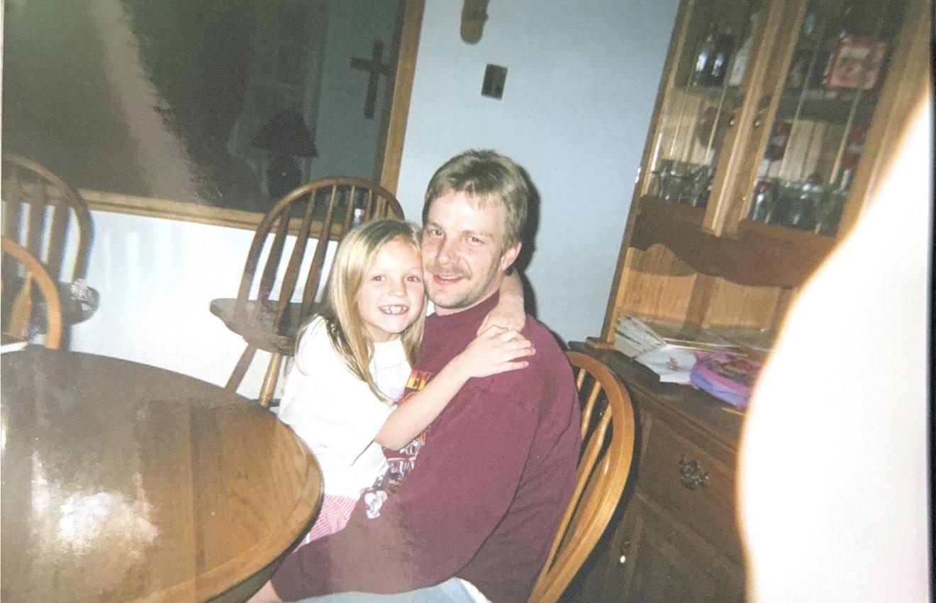 A man and a girl sitting at a table