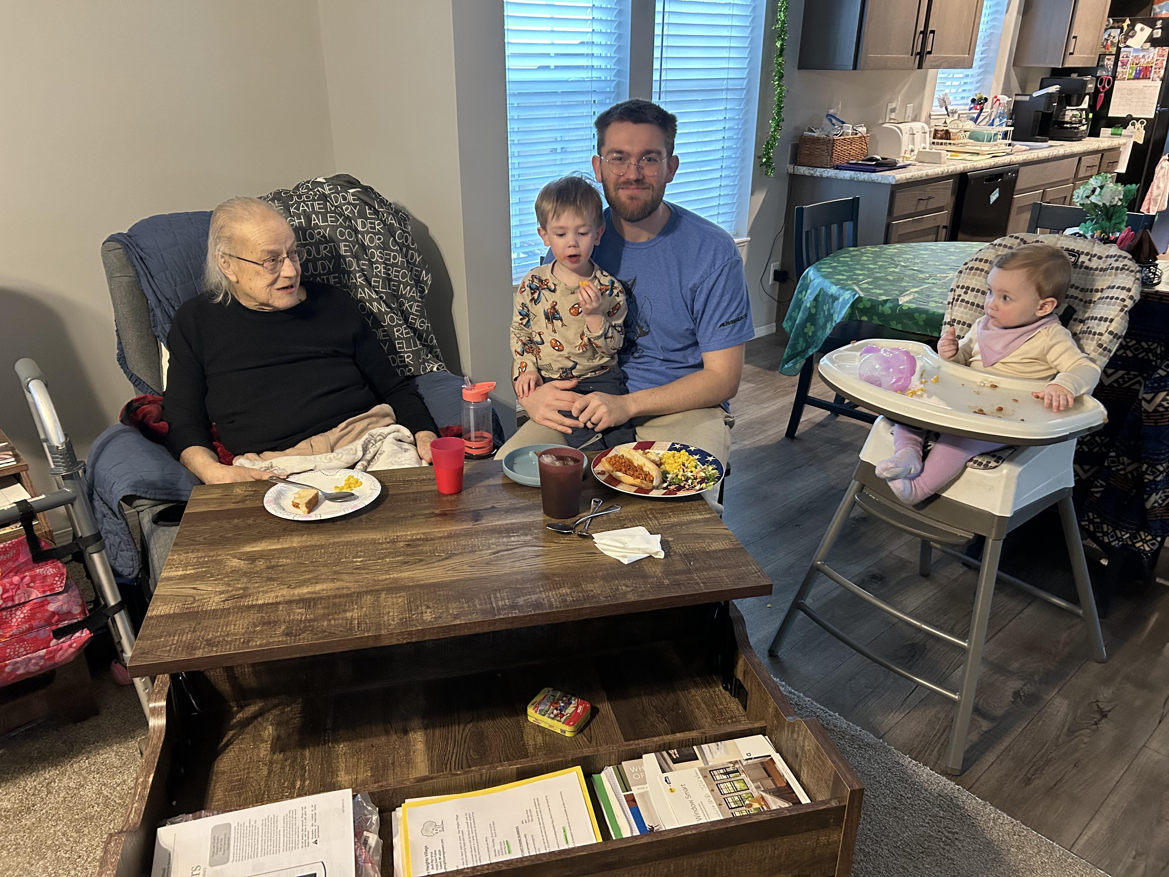 A group of people sitting at a table with food