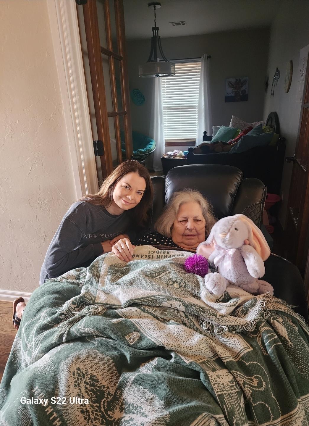 A woman and a woman sitting in a chair