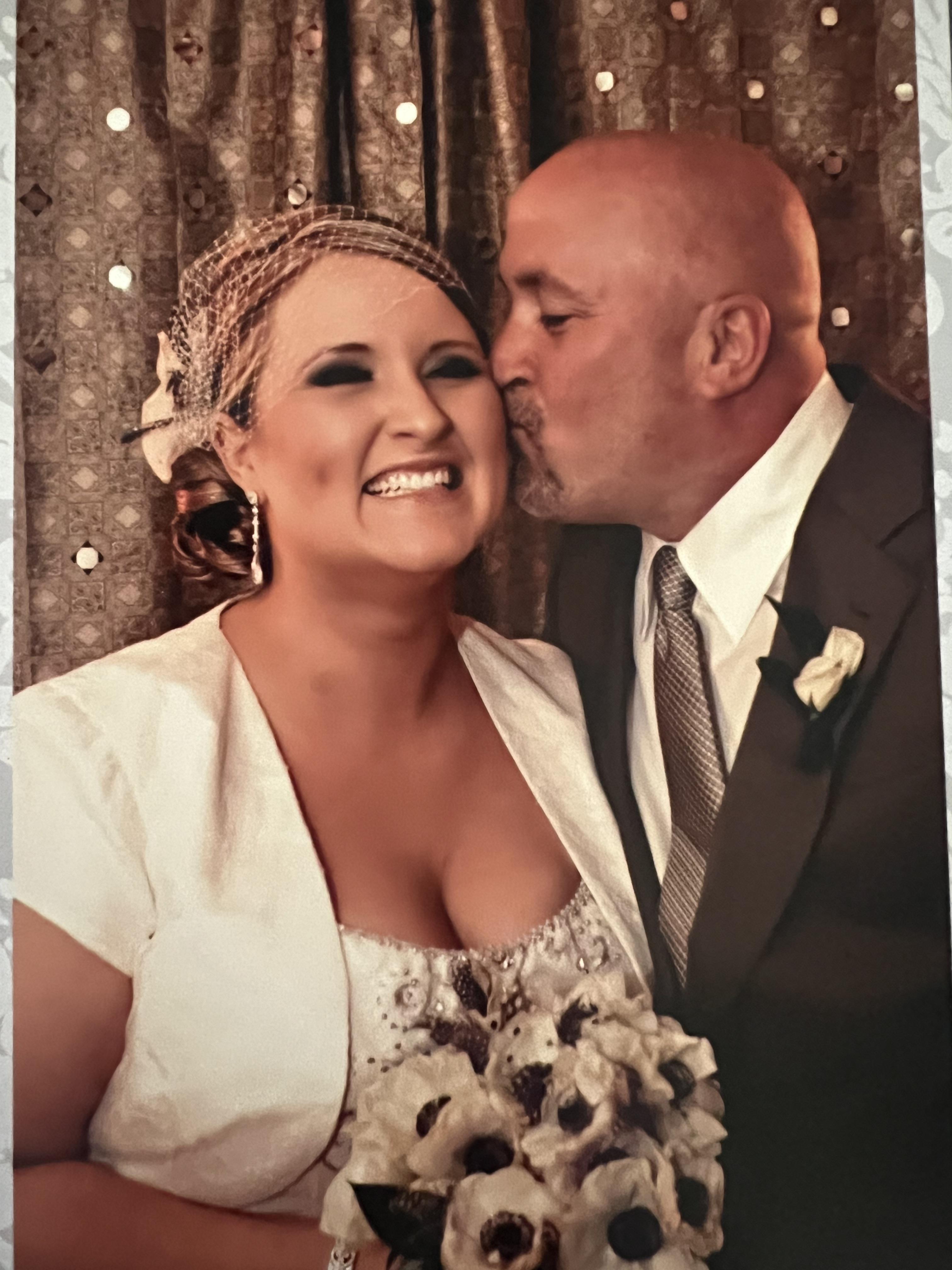 A man kissing a woman's cheek