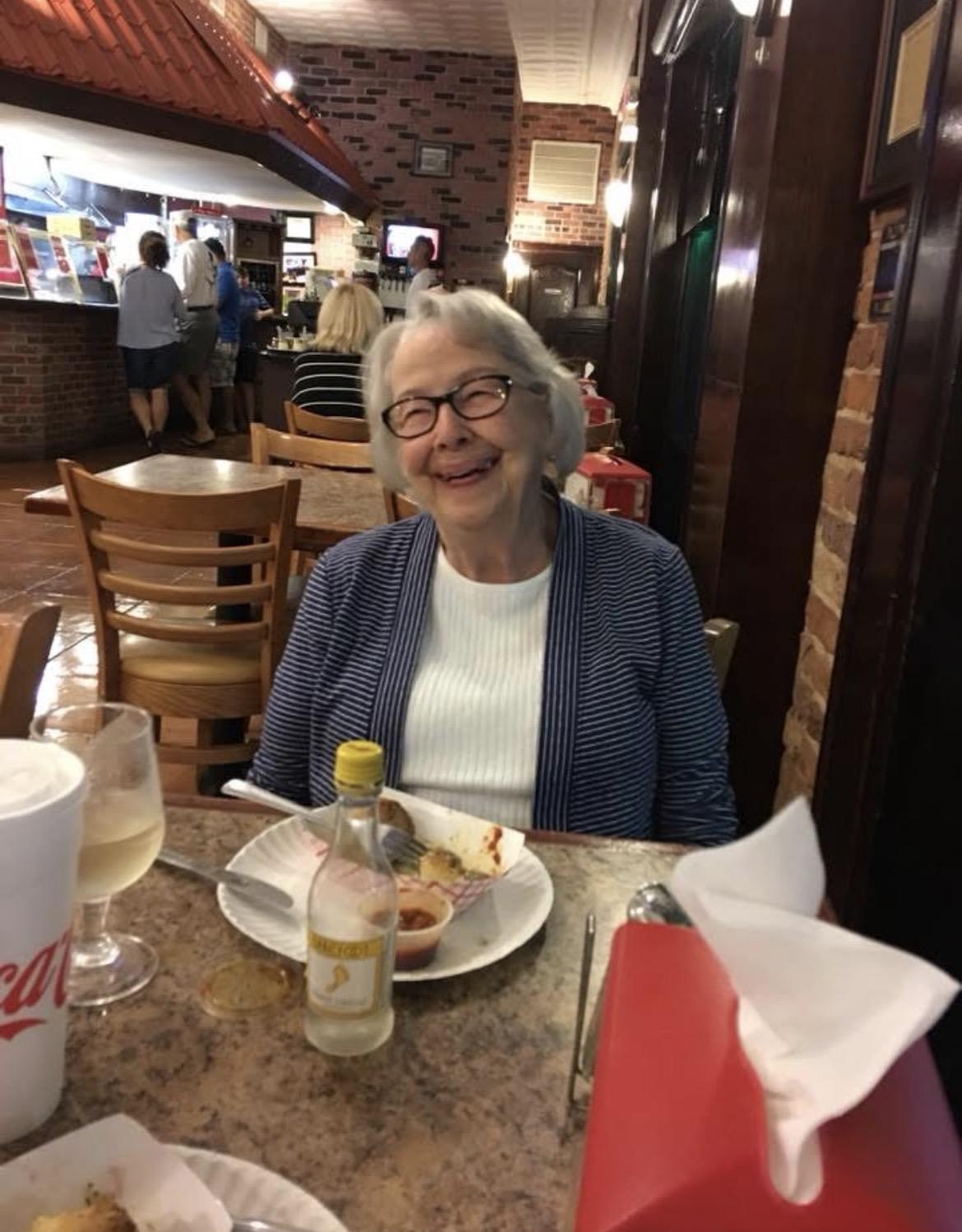 A woman sitting at a table with food
