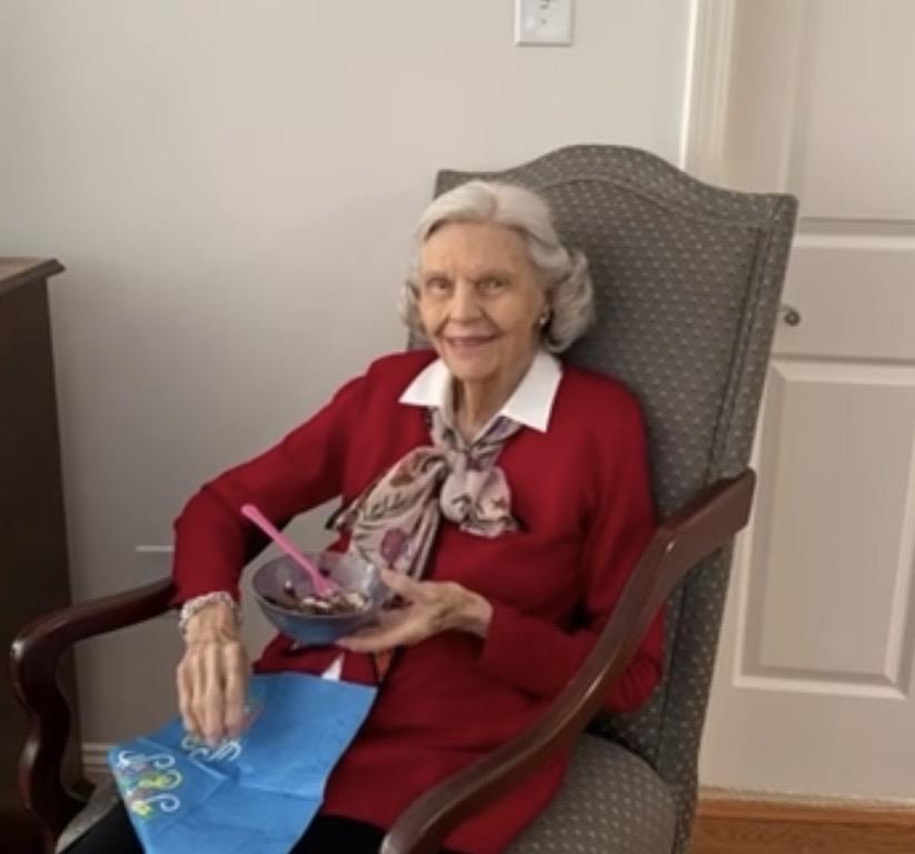 A woman sitting in a chair eating