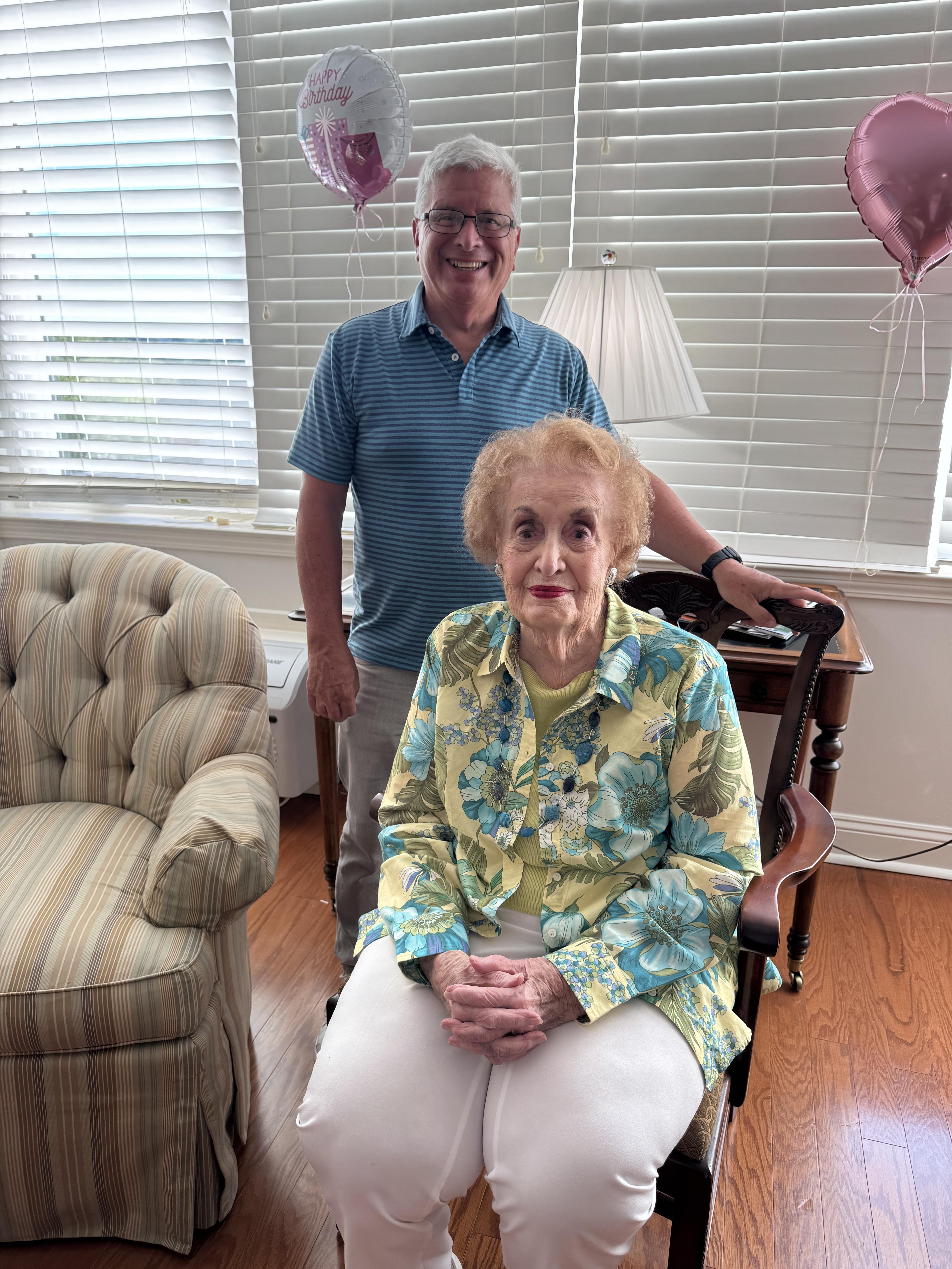 A man and woman sitting in a chair