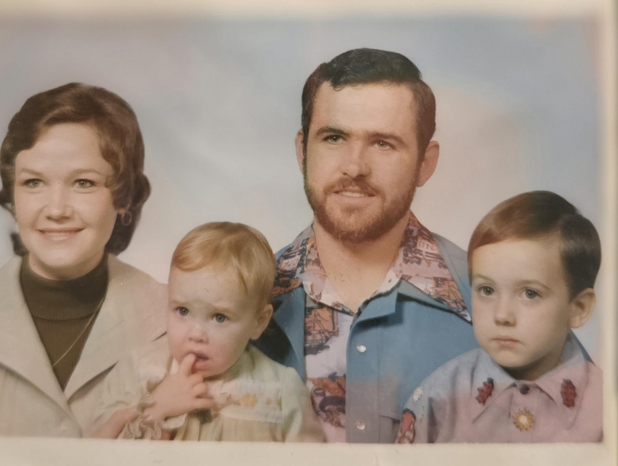 A family photo of a man and woman with two children