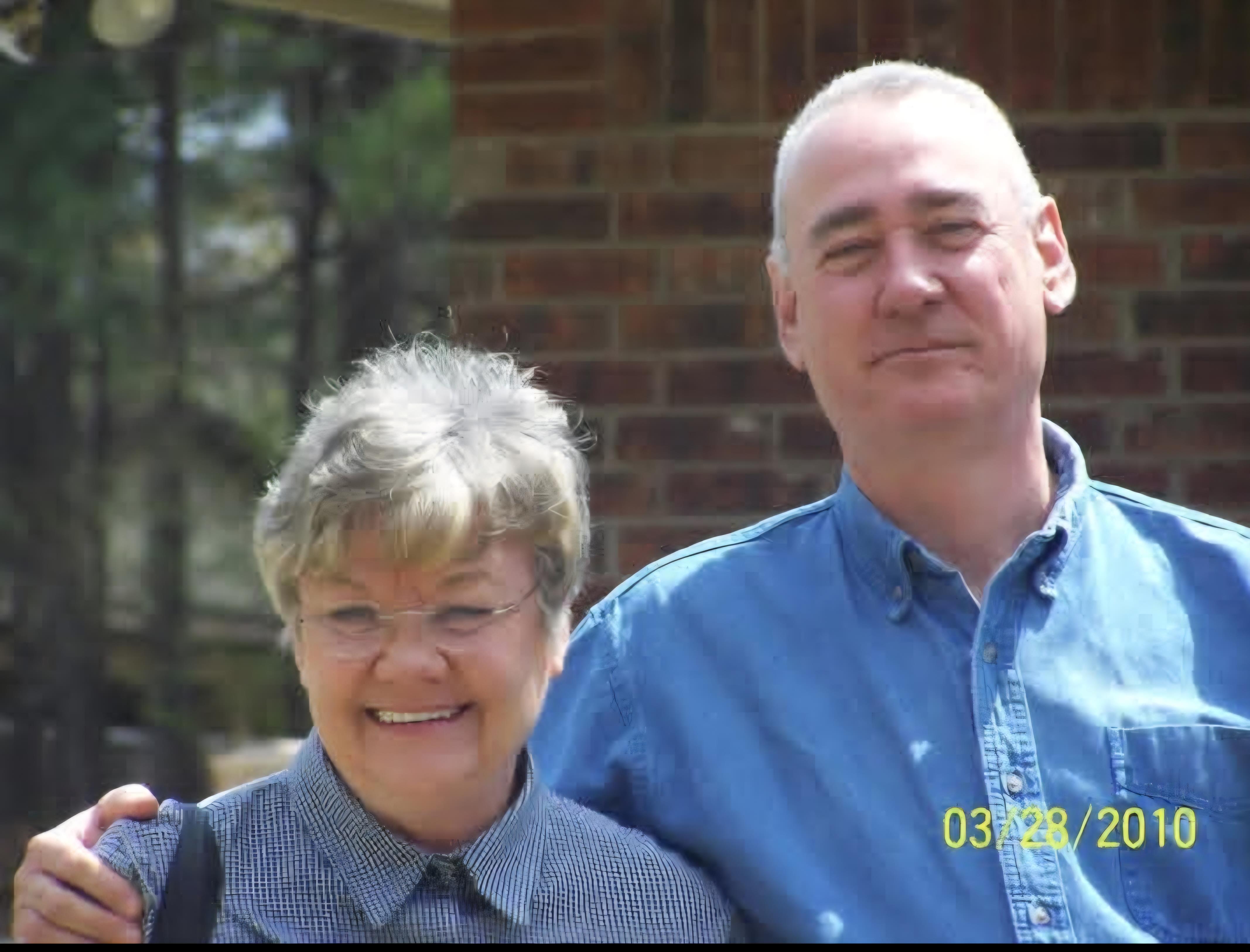 A man and woman posing for a picture