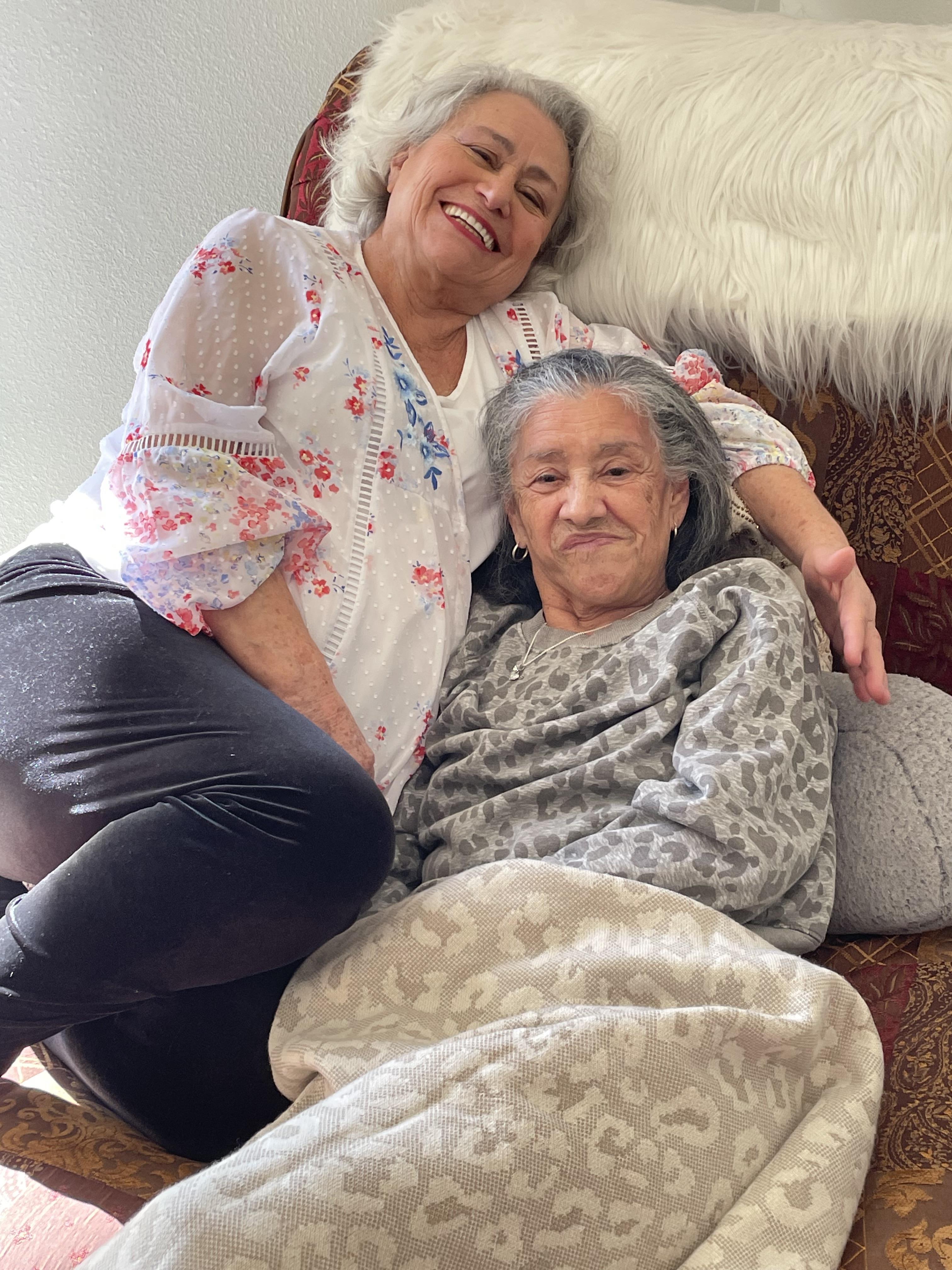 Two women sitting on a couch