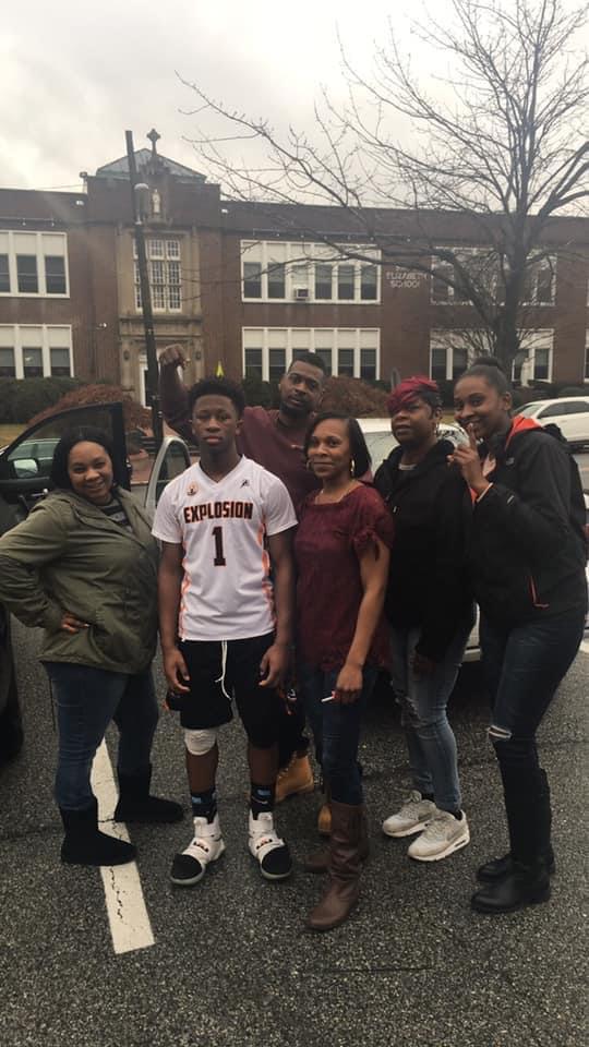 A group of people standing in front of a building