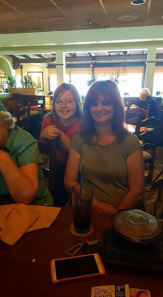 A woman and a girl sitting at a table