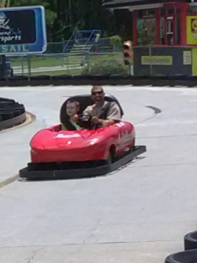 A man and boy driving a bumper car