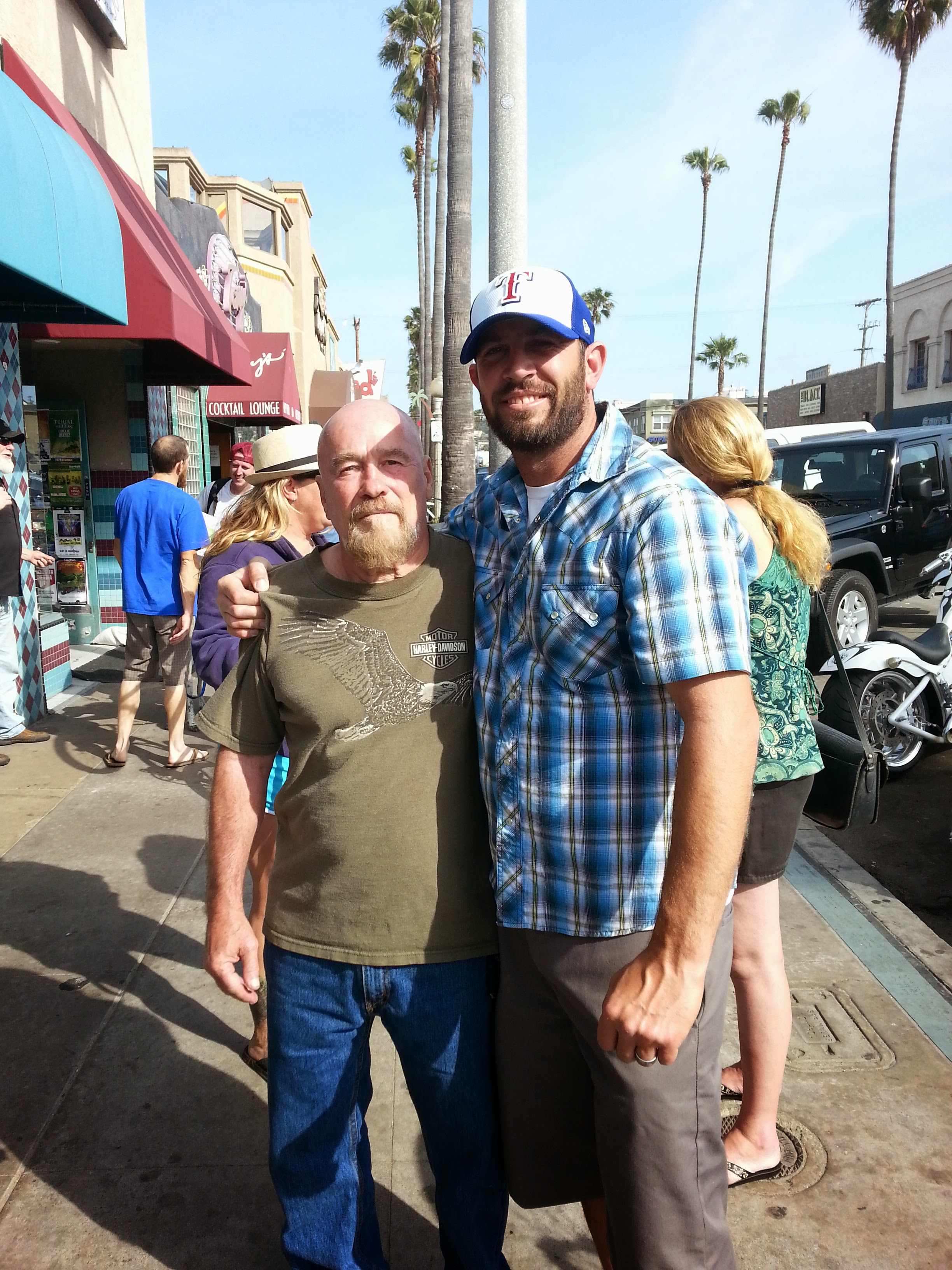 Two men standing on a sidewalk