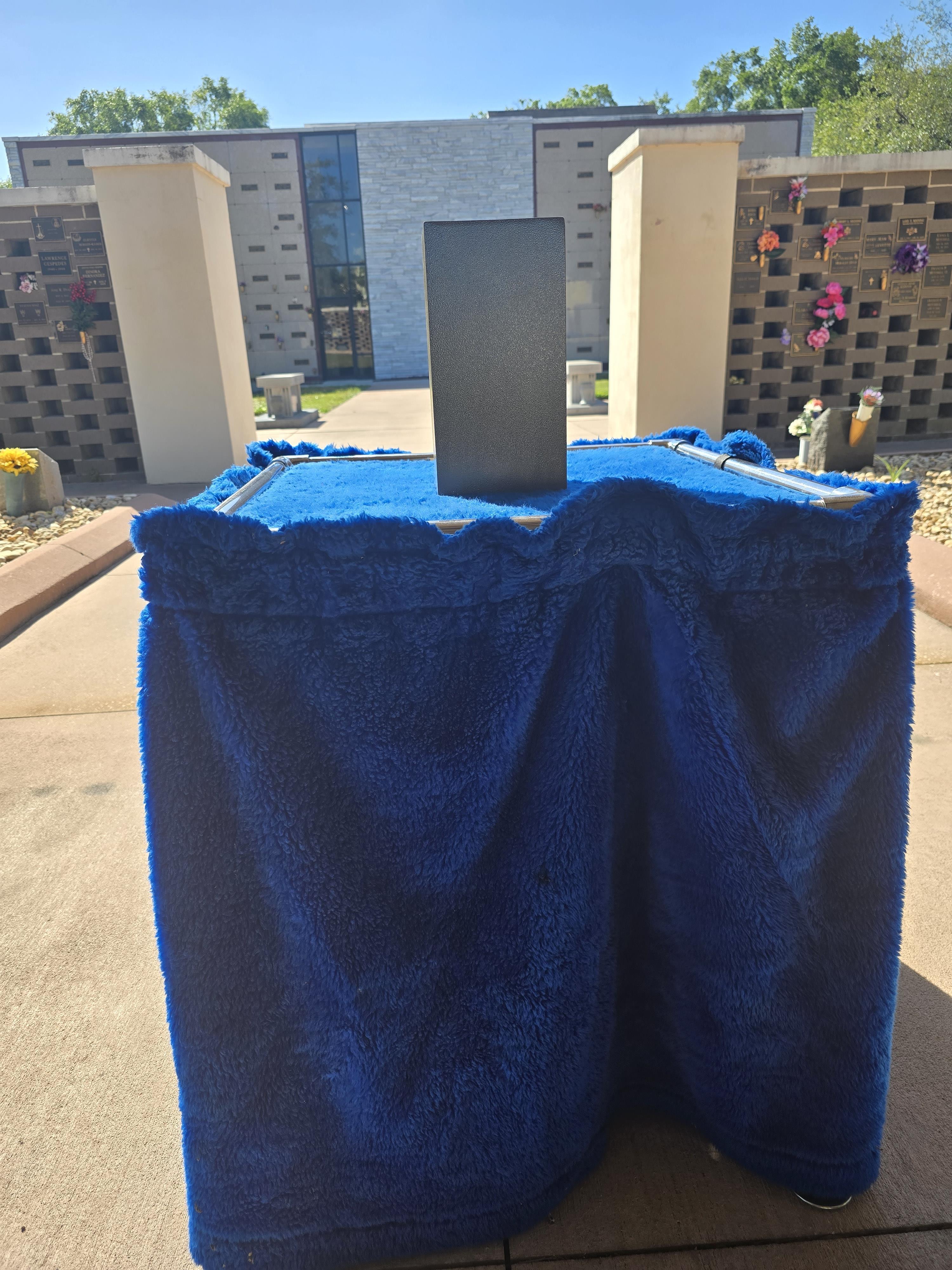 A blue table with a black rectangular object on it