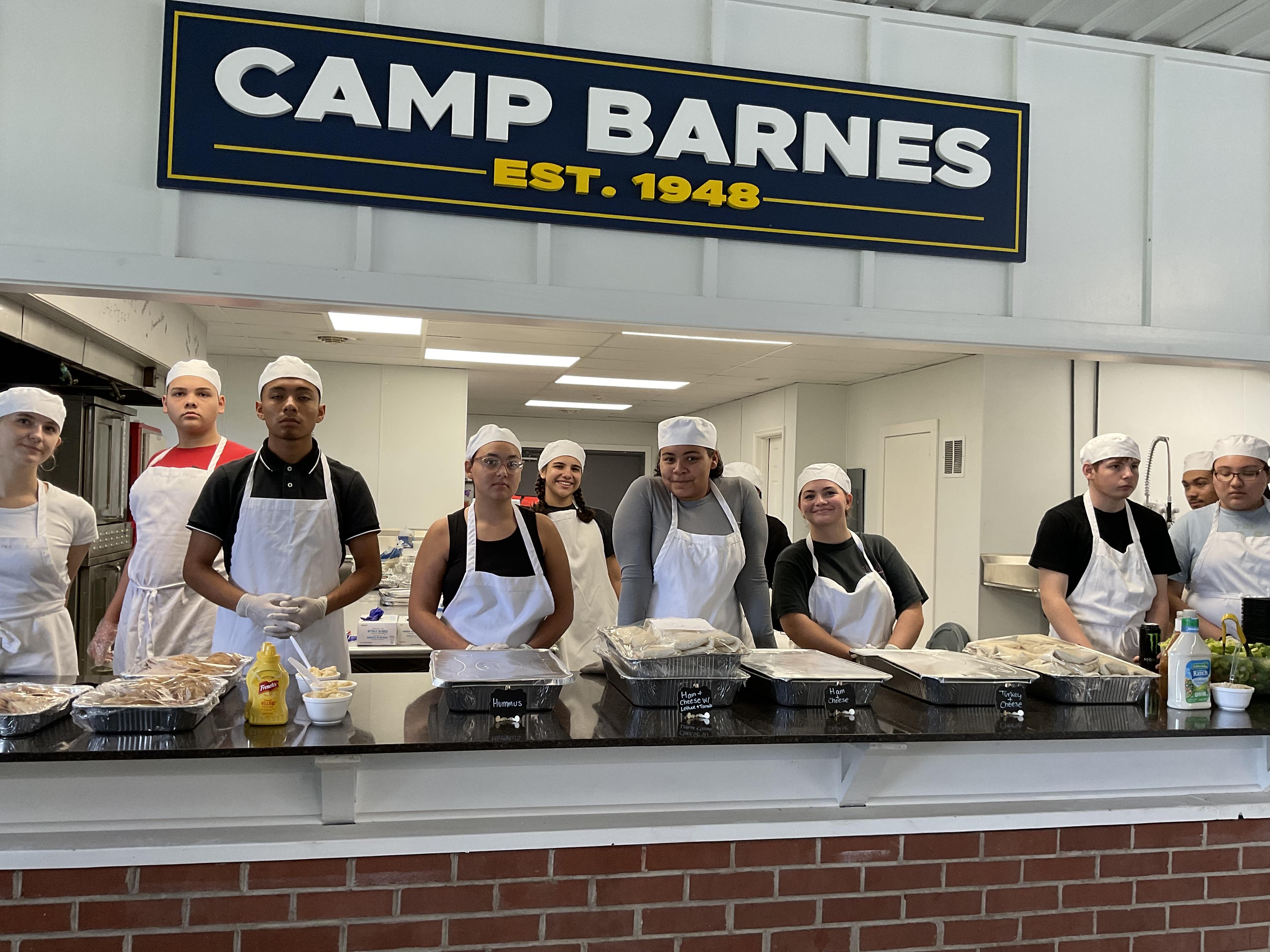 A group of people standing in front of a sign