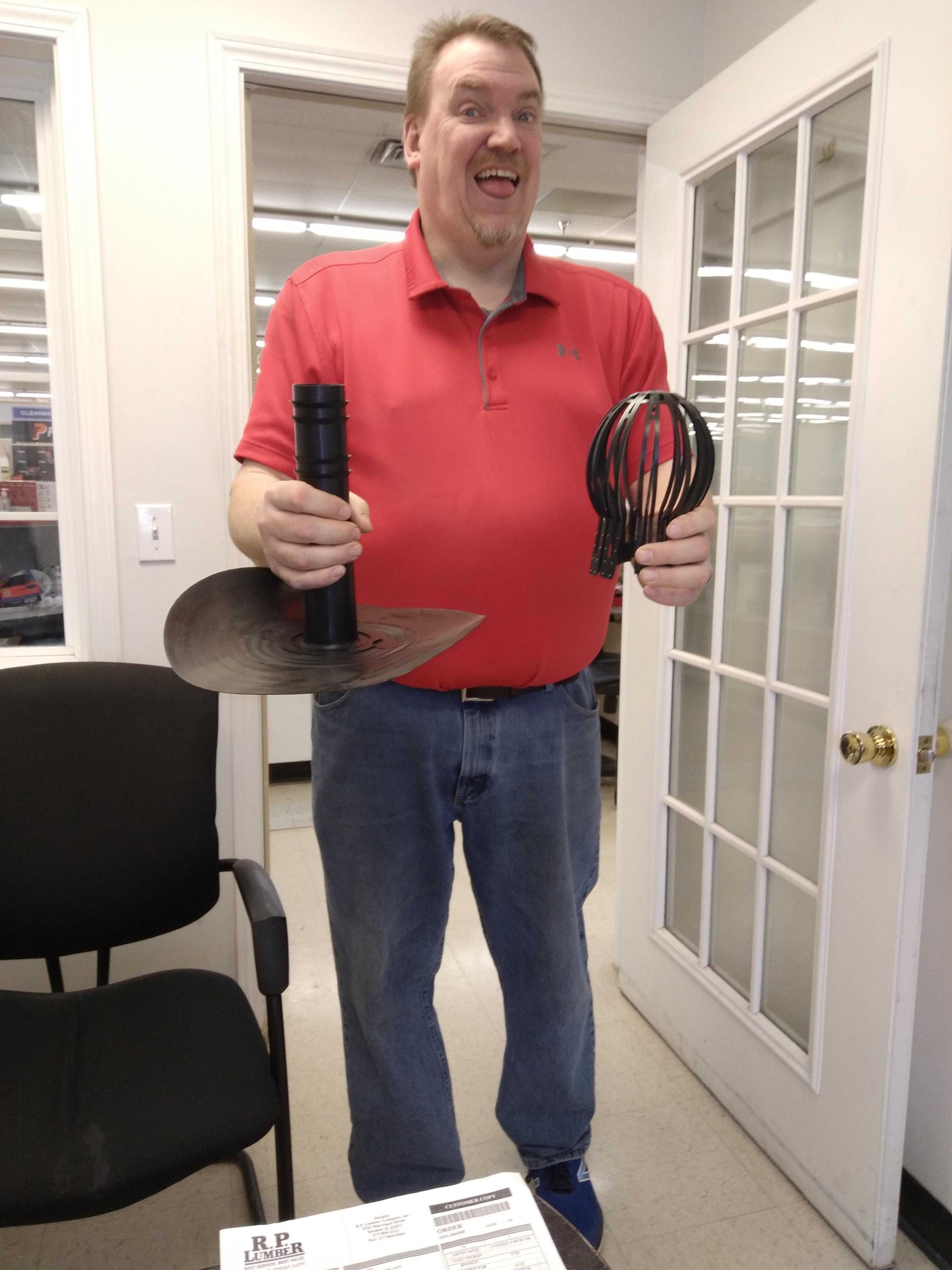 A man holding a black object and a black object