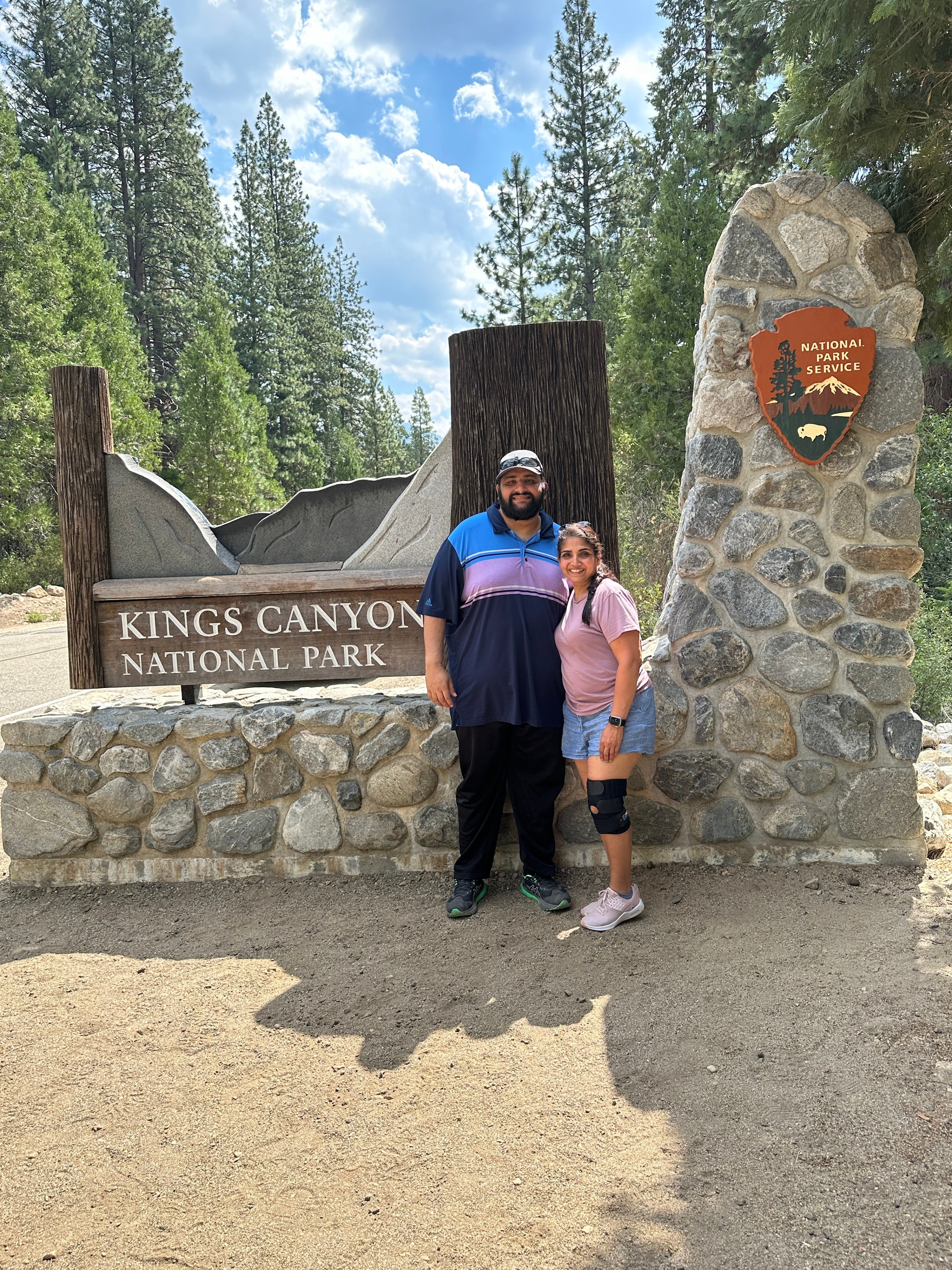 A man and woman standing in front of a sign