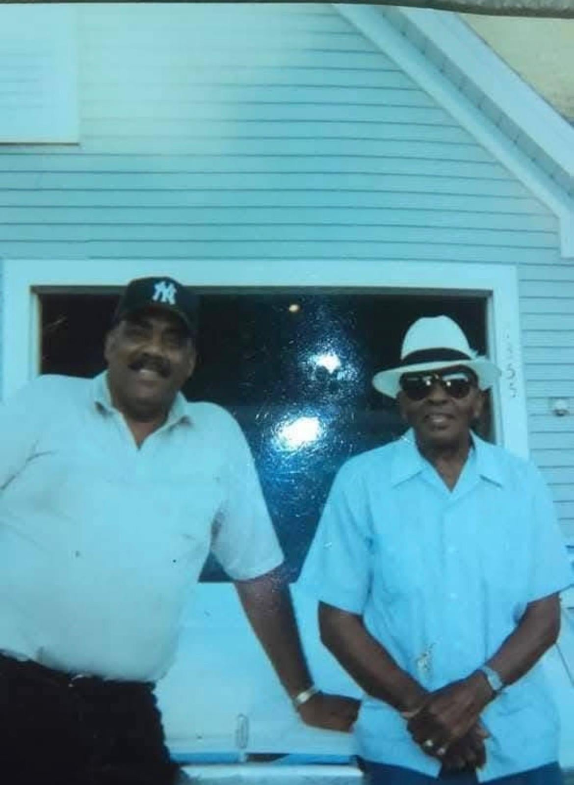 Two men standing in front of a window