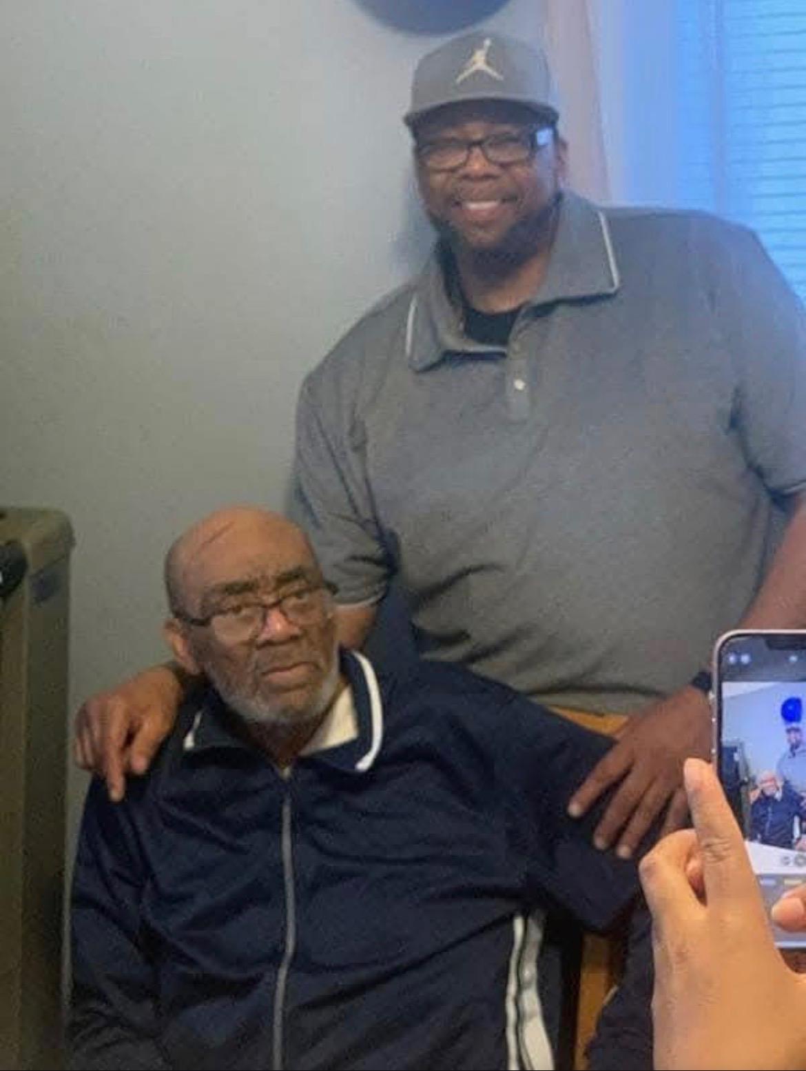 A man sitting next to another man
