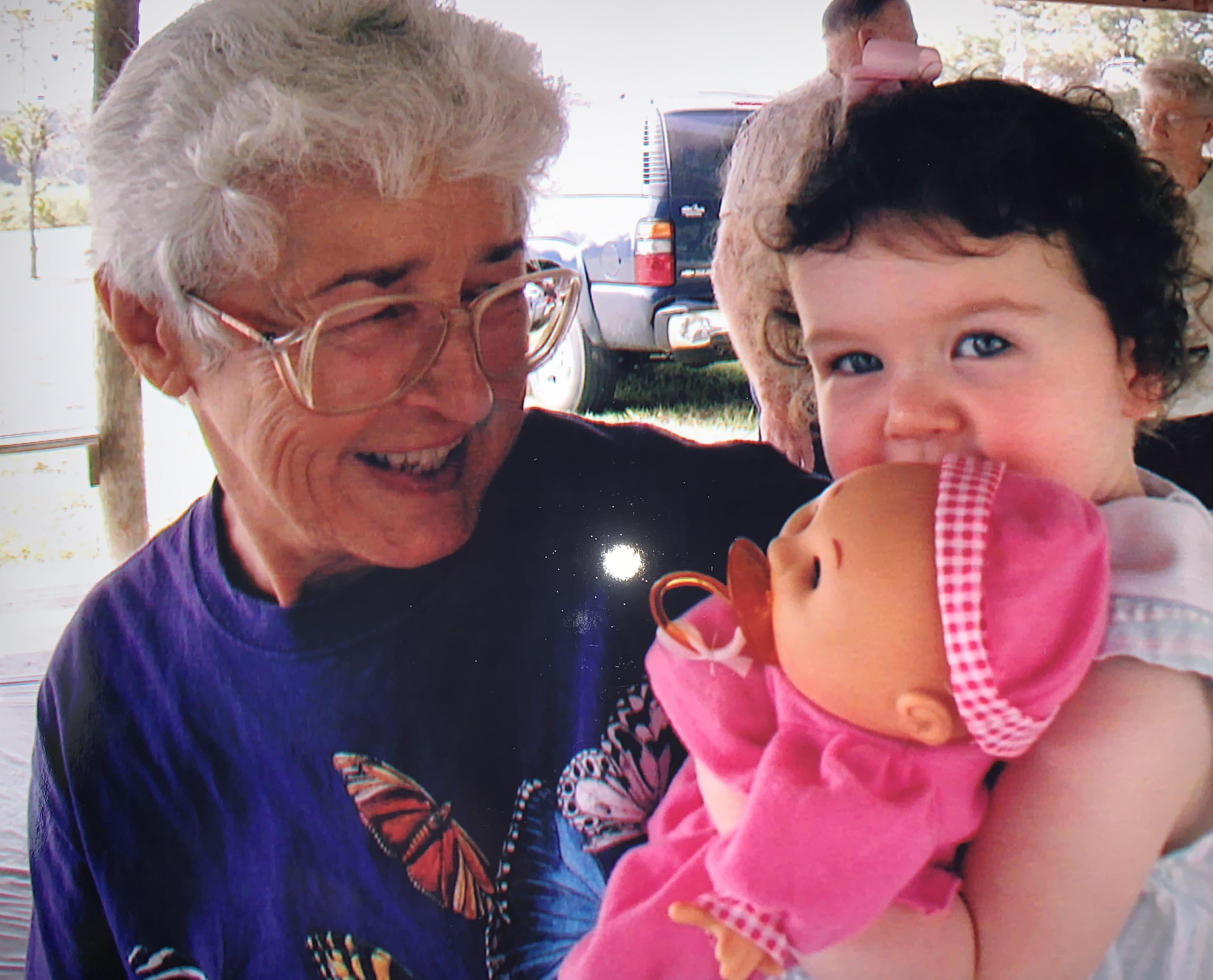 A woman holding a baby doll