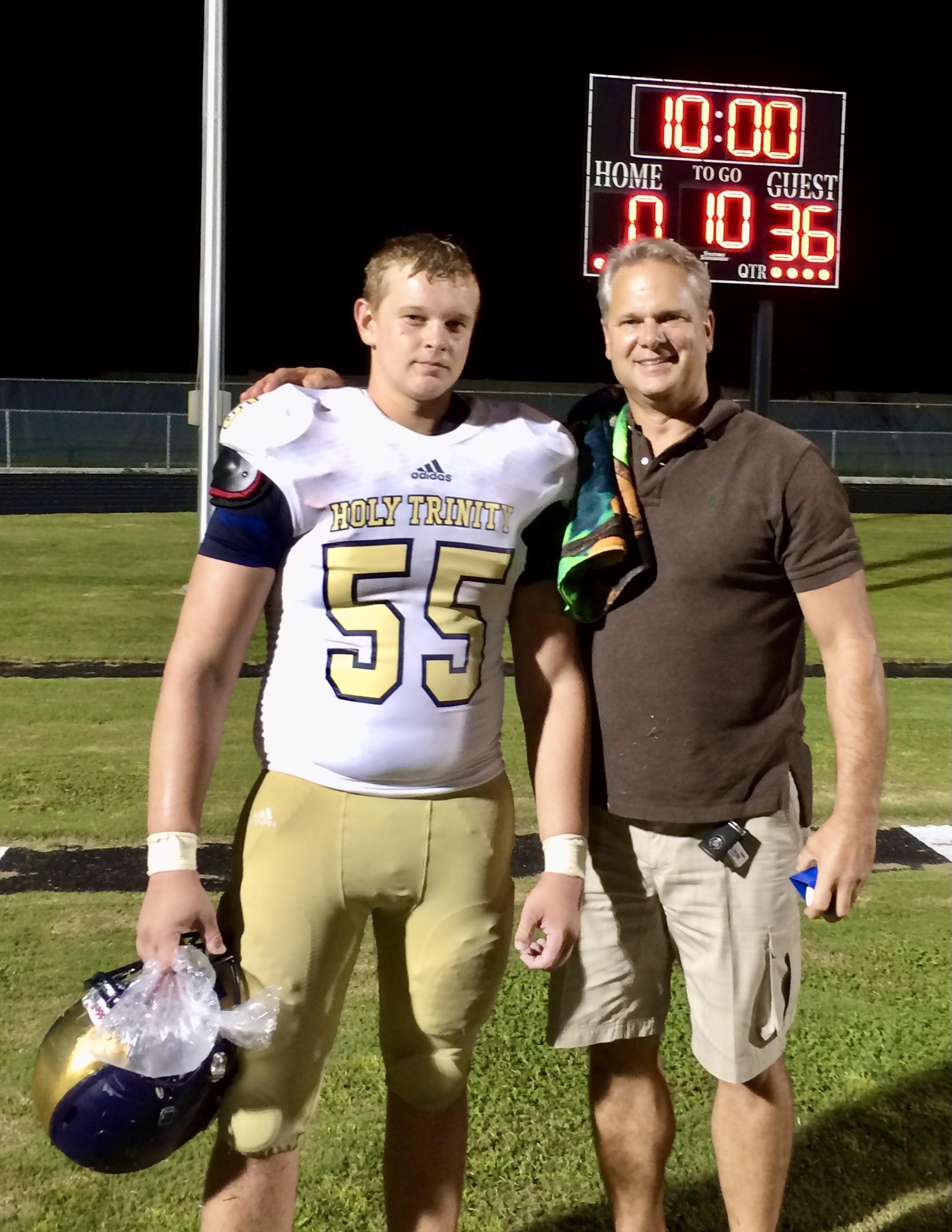 Two men standing on a football field