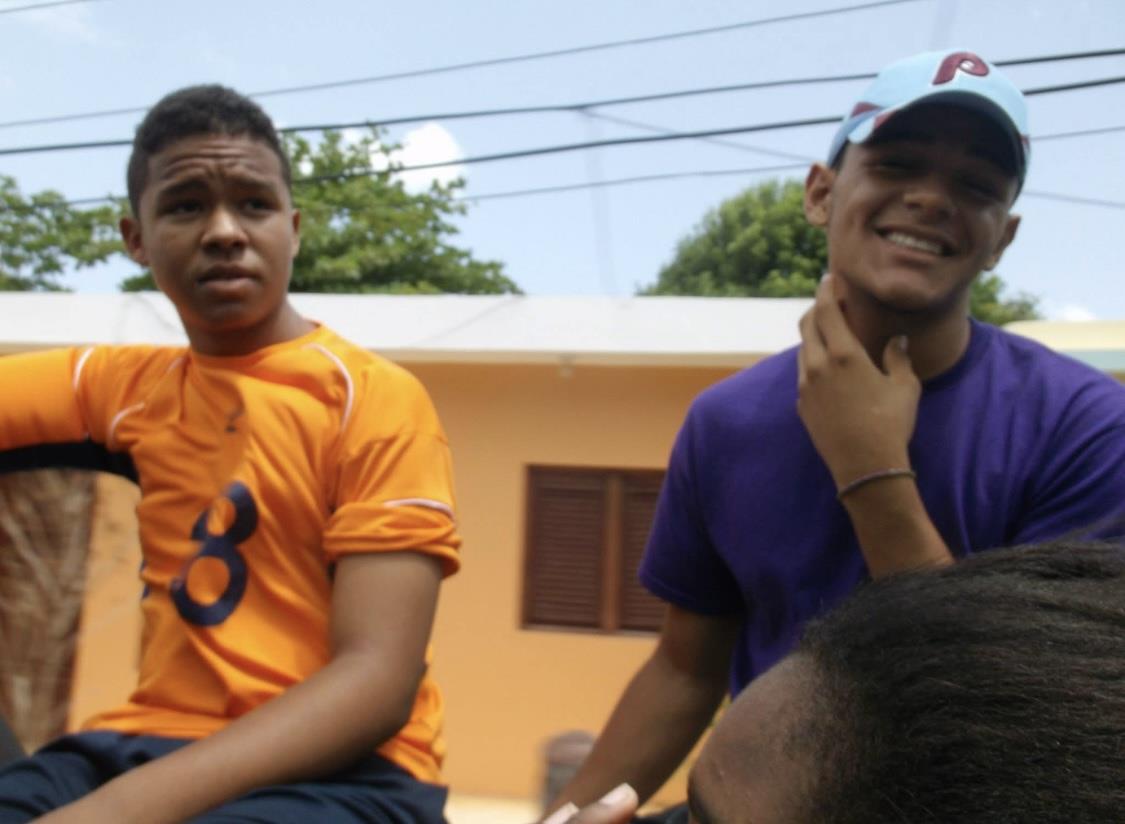A group of boys sitting on a bench