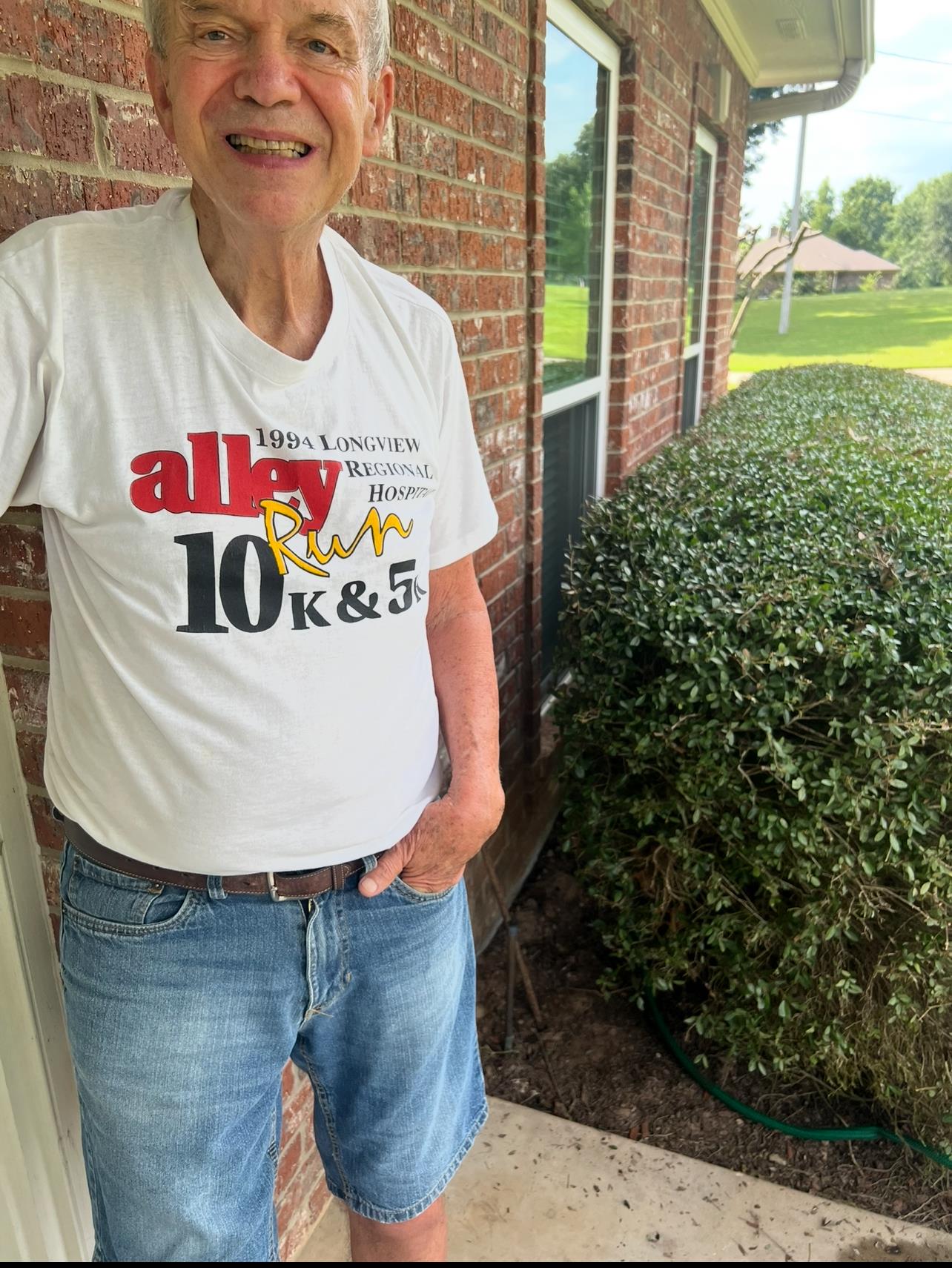 A woman standing in front of a brick building