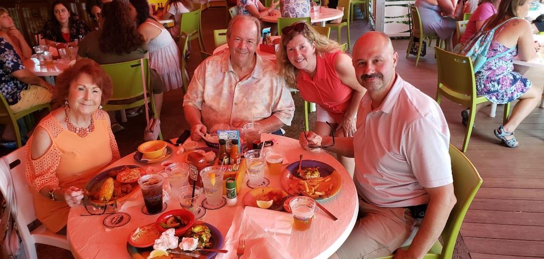 A group of people sitting at a table with food