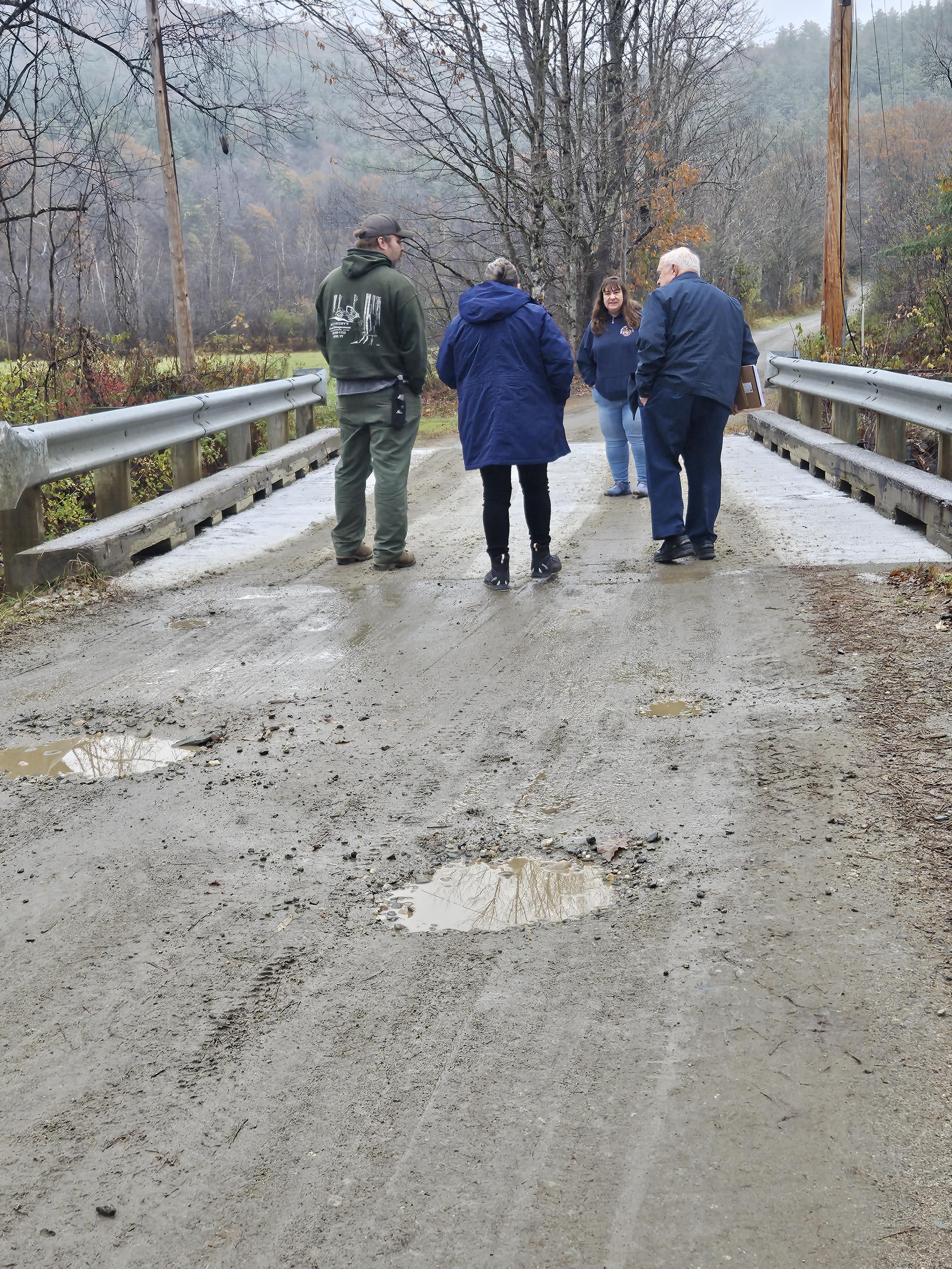 A group of people walking on a bridge