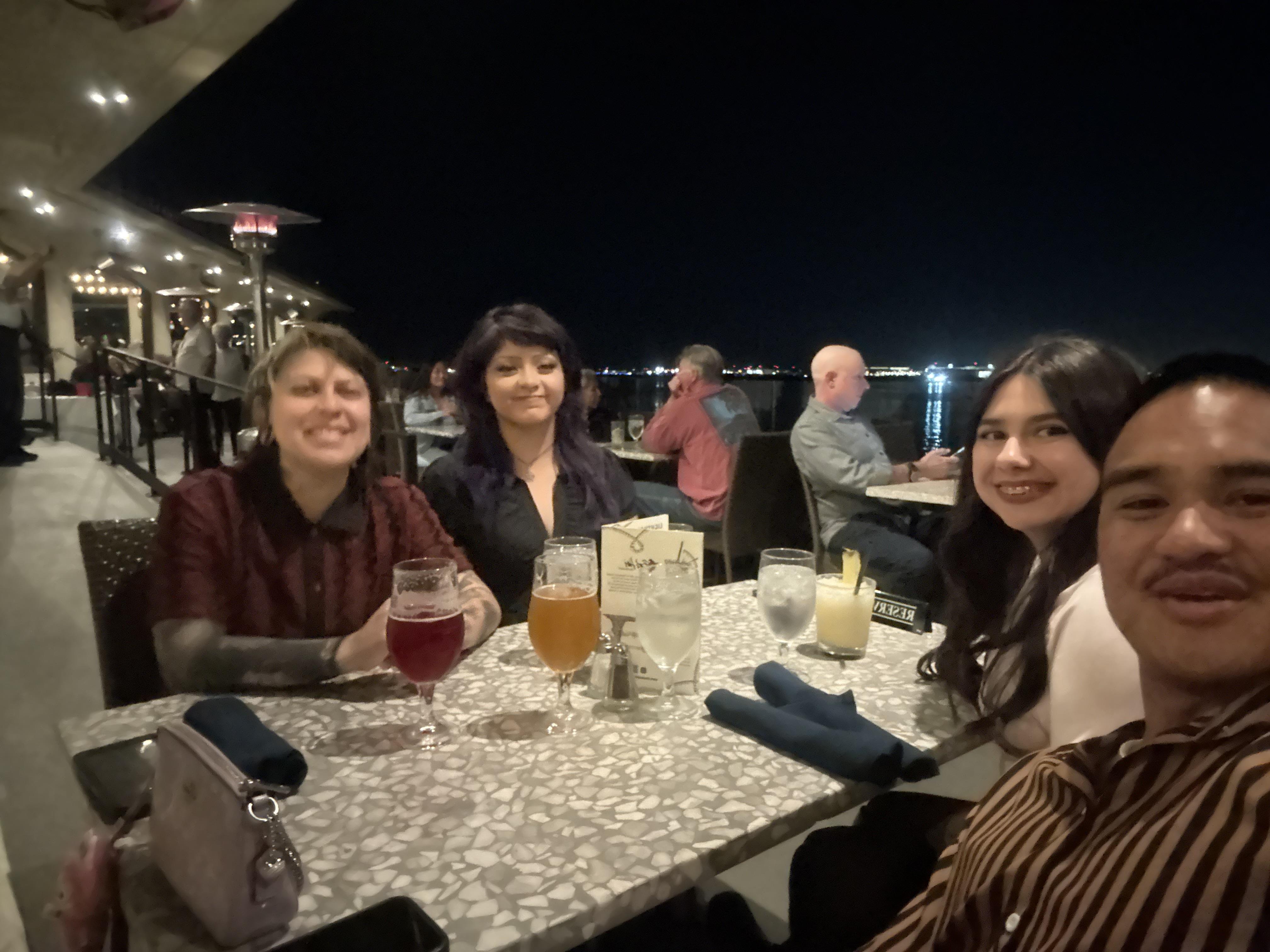 A group of women sitting at a table with drinks