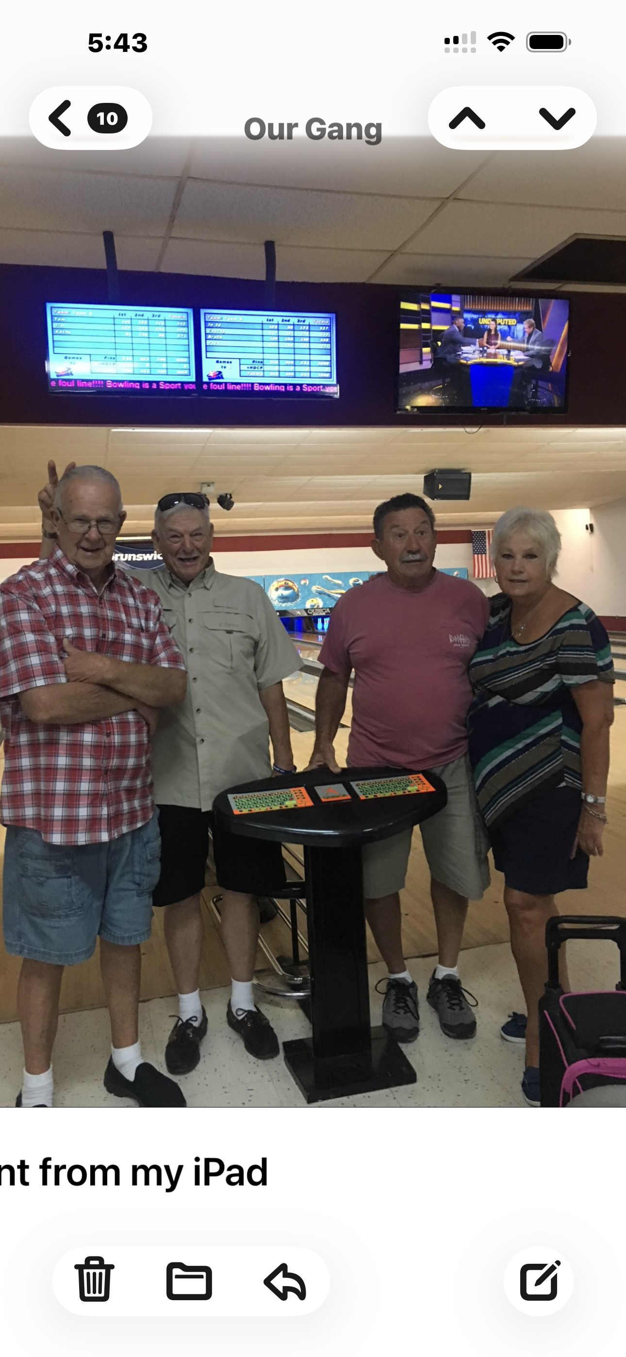 A group of people standing in a bowling alley