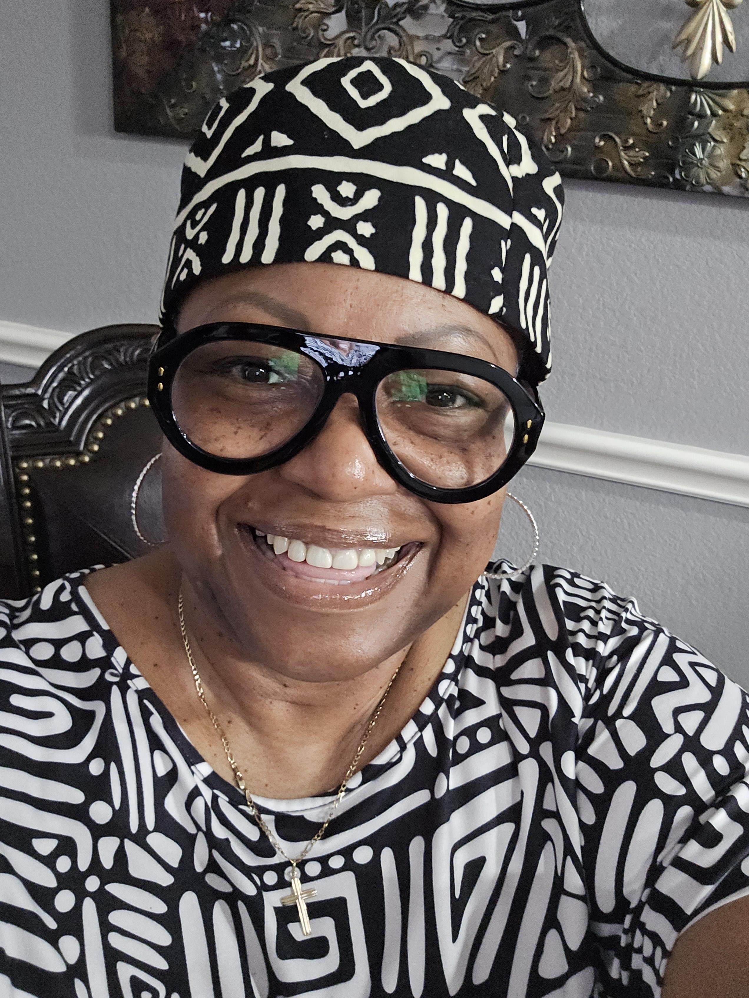 A woman wearing glasses and a headdress