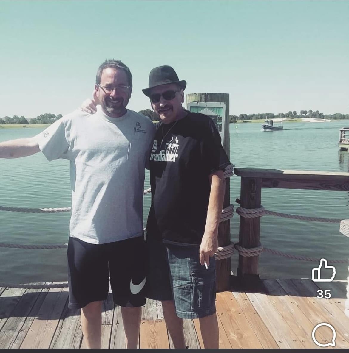 Two men standing on a dock