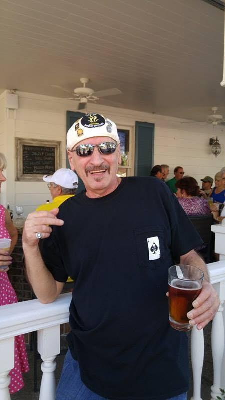A man holding a glass of beer