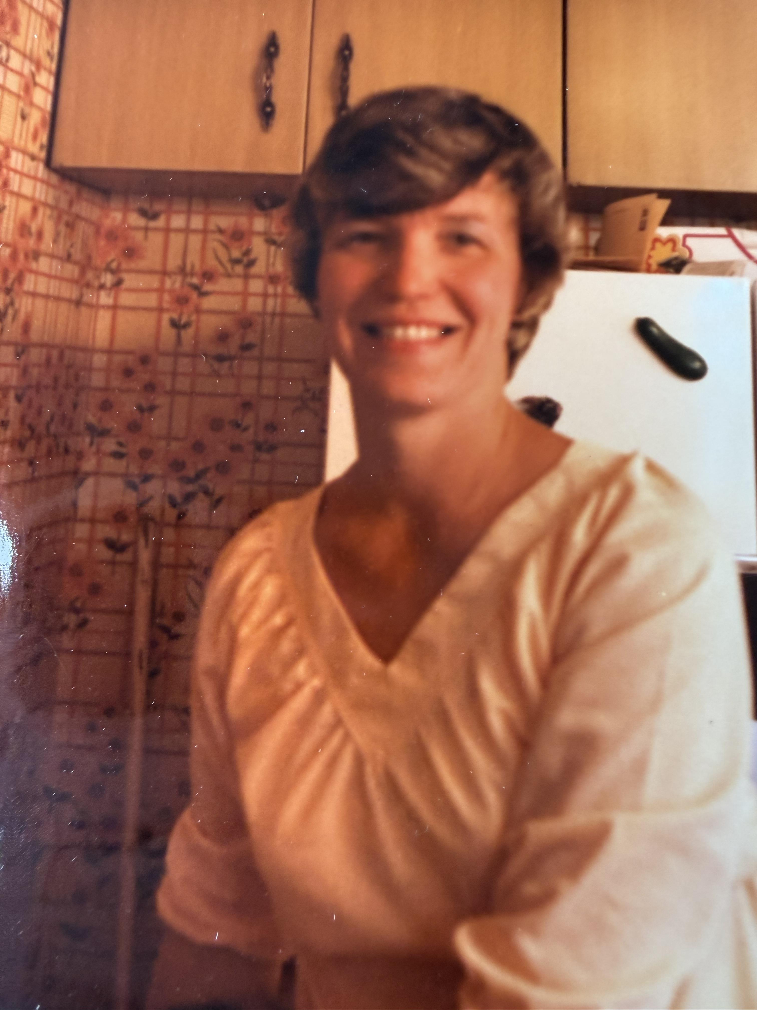 A woman smiling in a kitchen