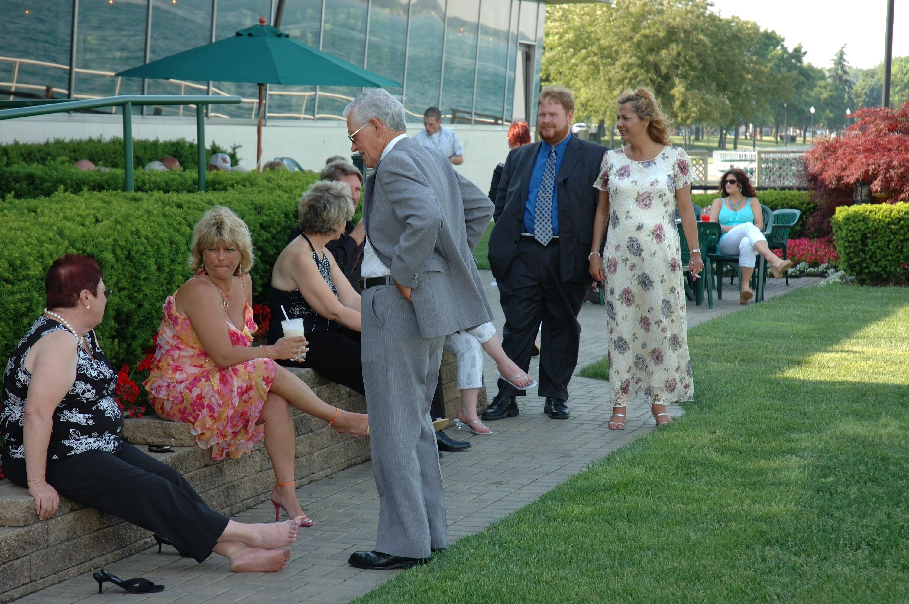 A group of people standing on a sidewalk