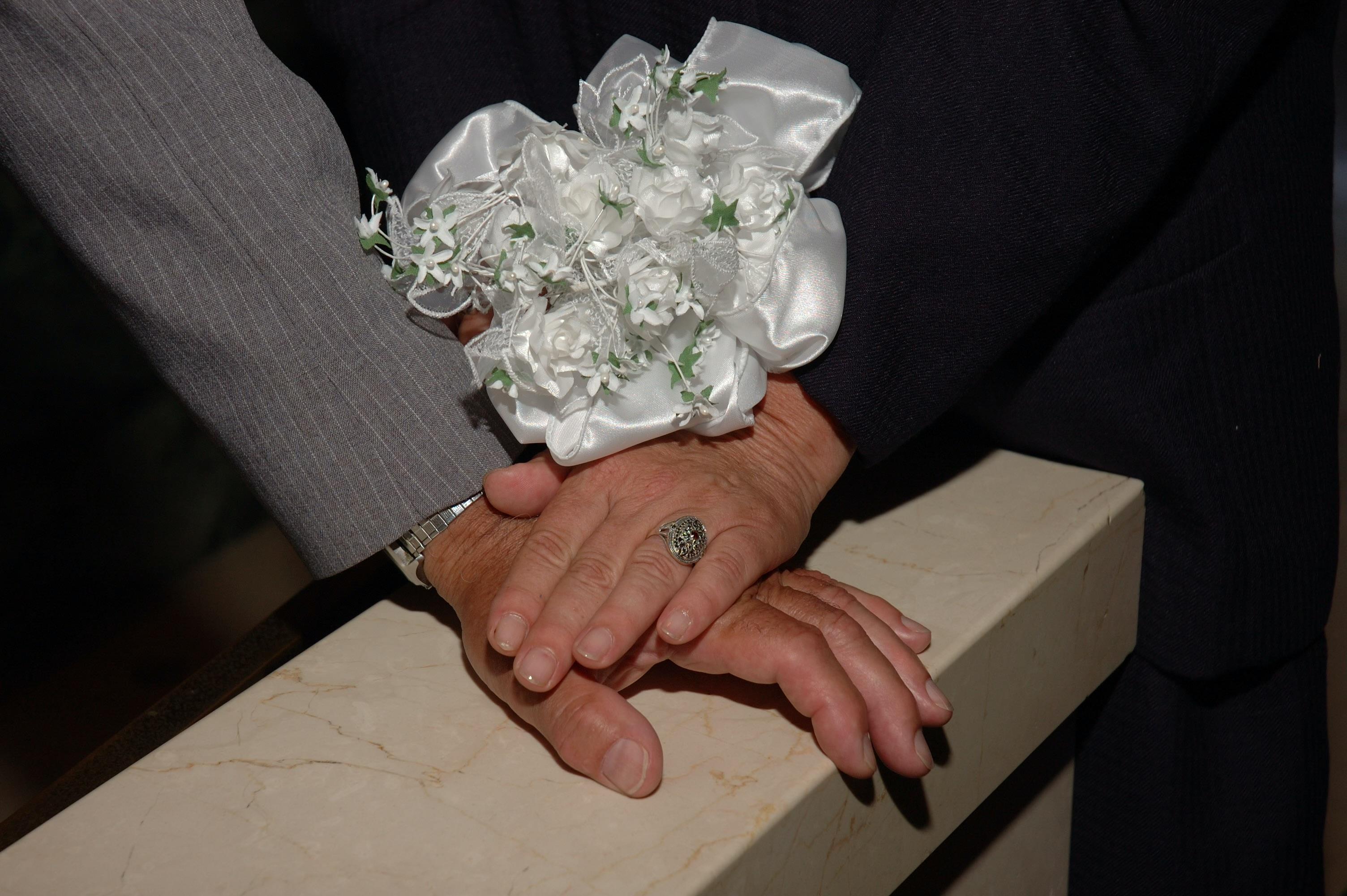 A close-up of hands holding flowers