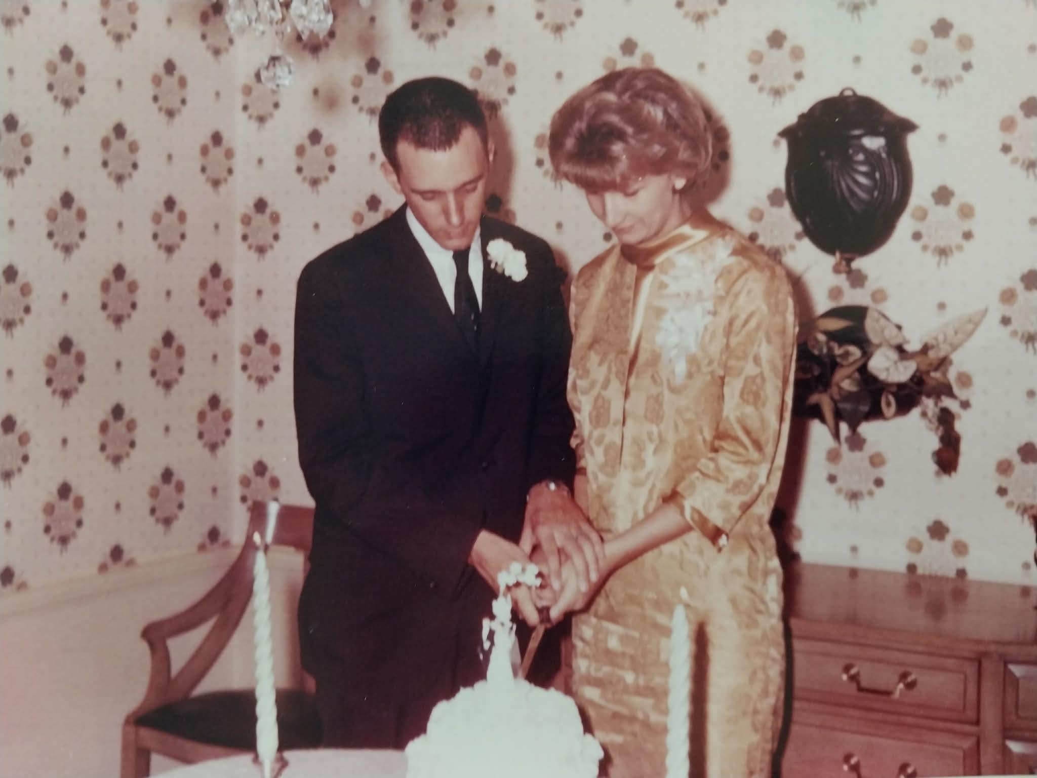 A man and woman cutting a cake