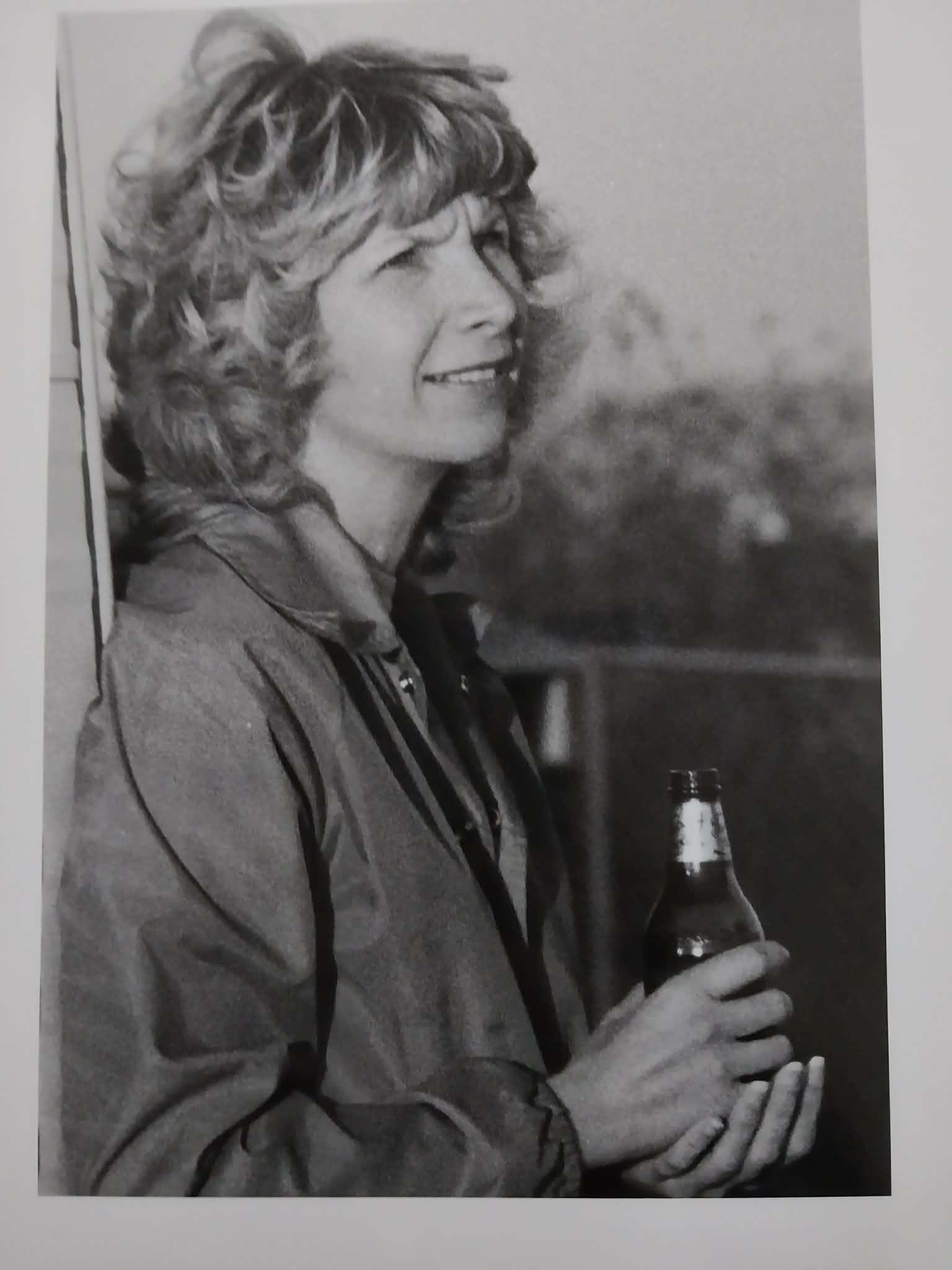 A woman holding a bottle