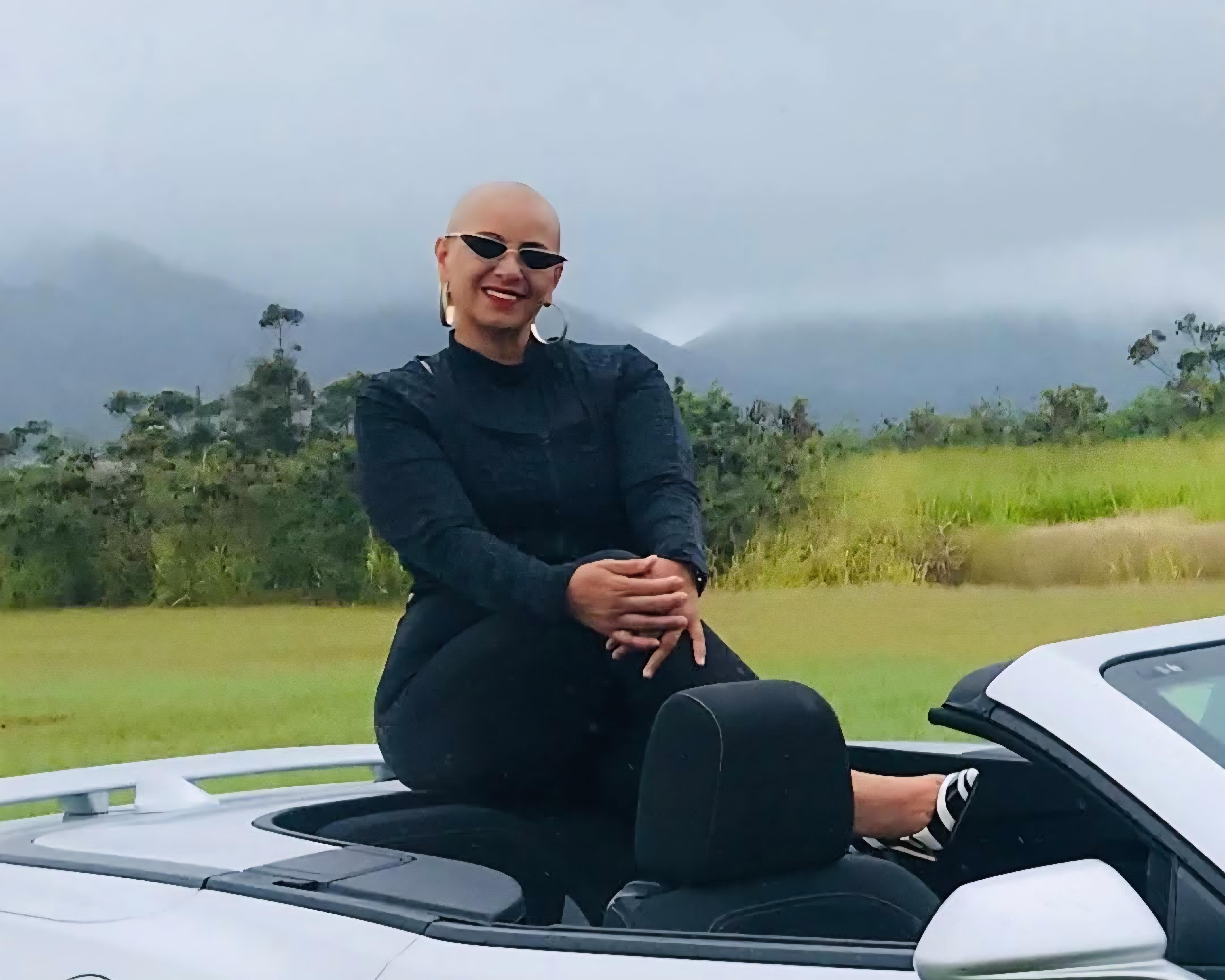 A woman sitting in a convertible car
