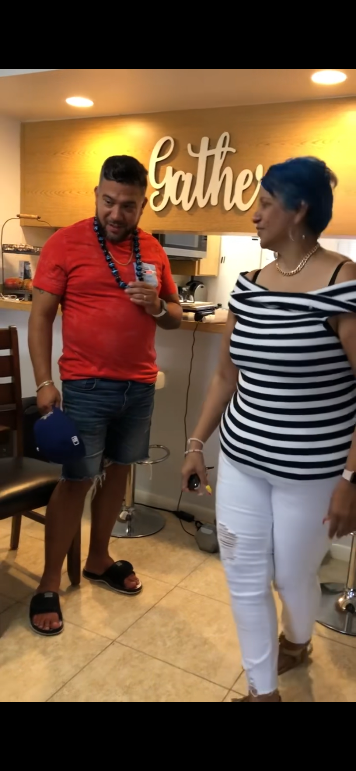A man and woman standing in a kitchen
