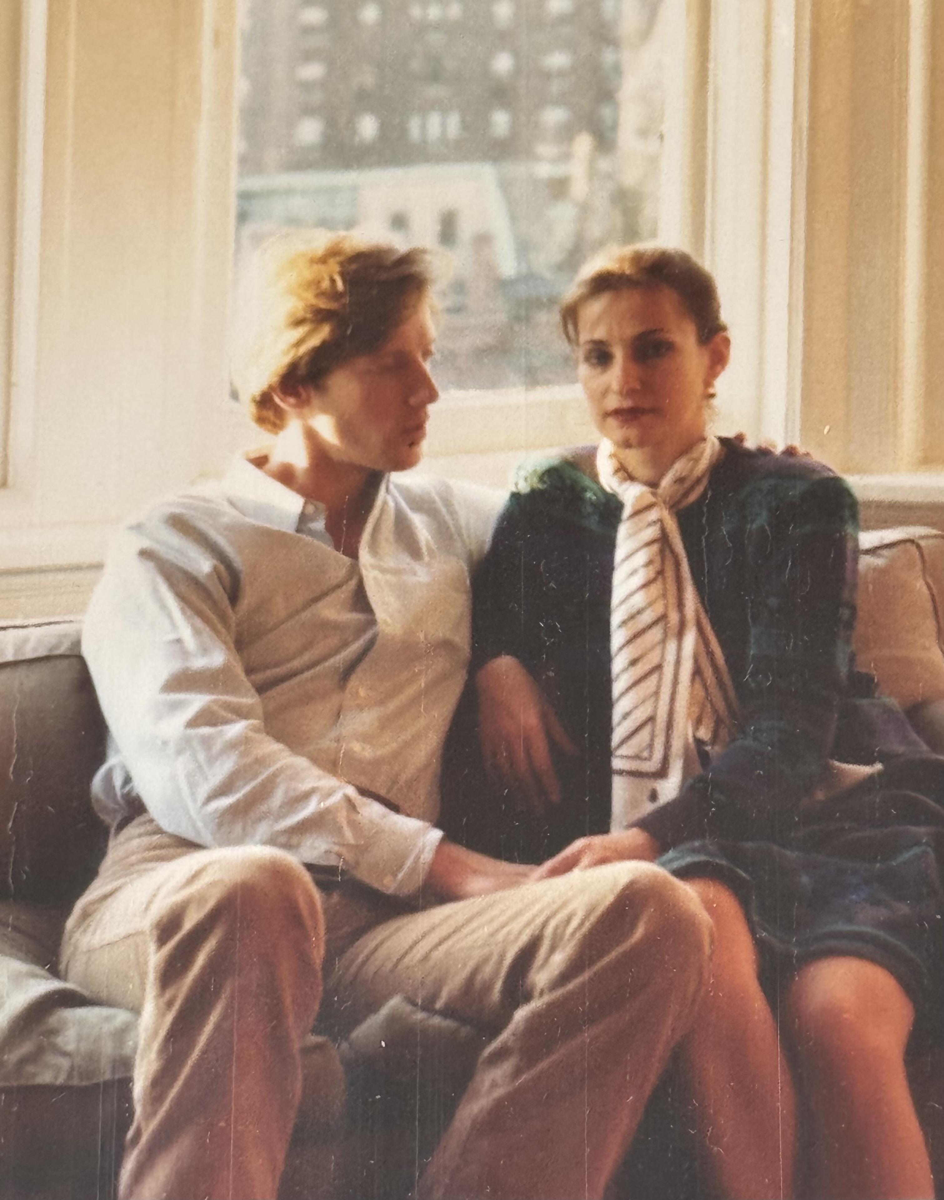 A man and woman sitting on a couch