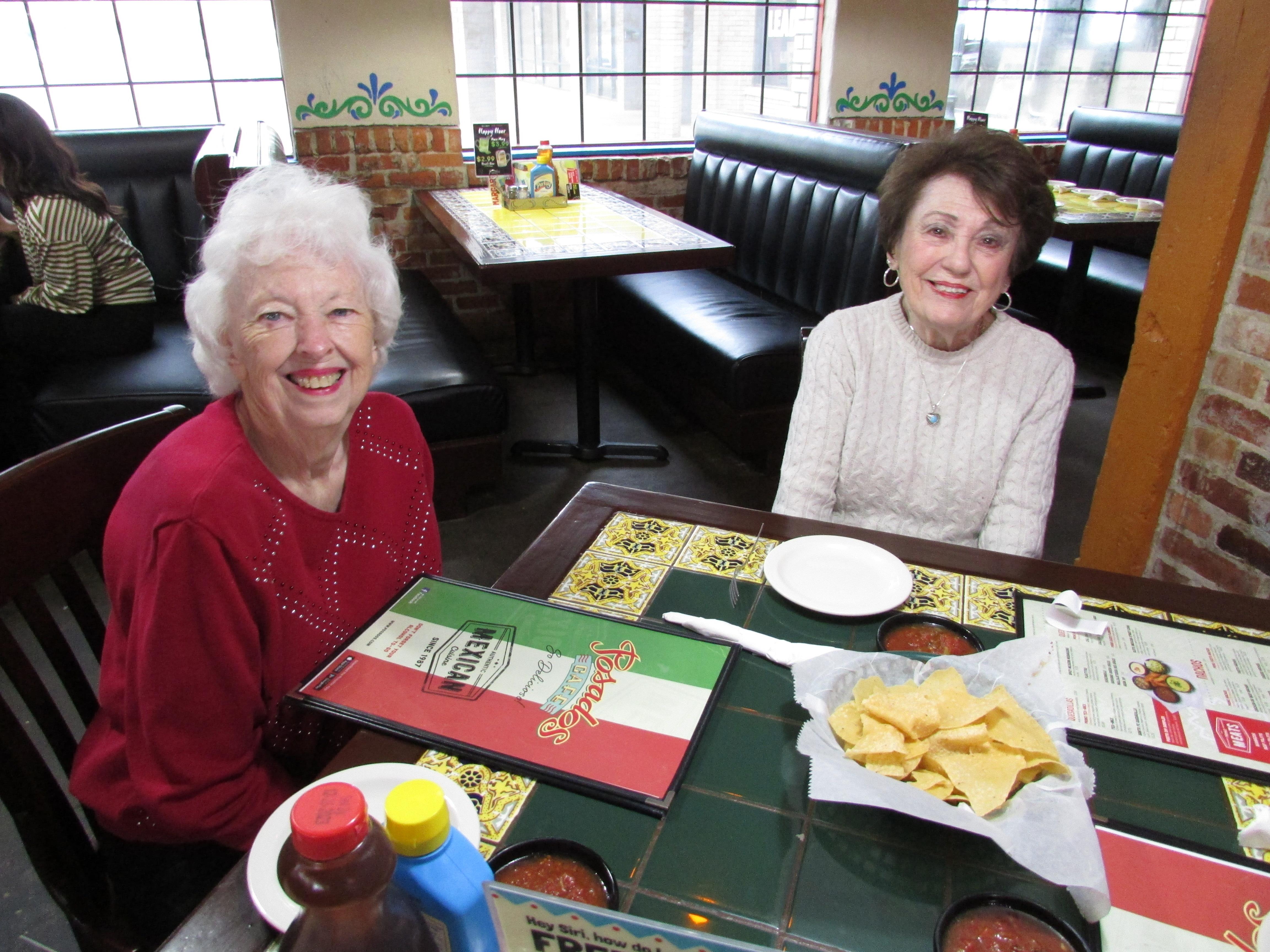 A couple of women sitting at a table