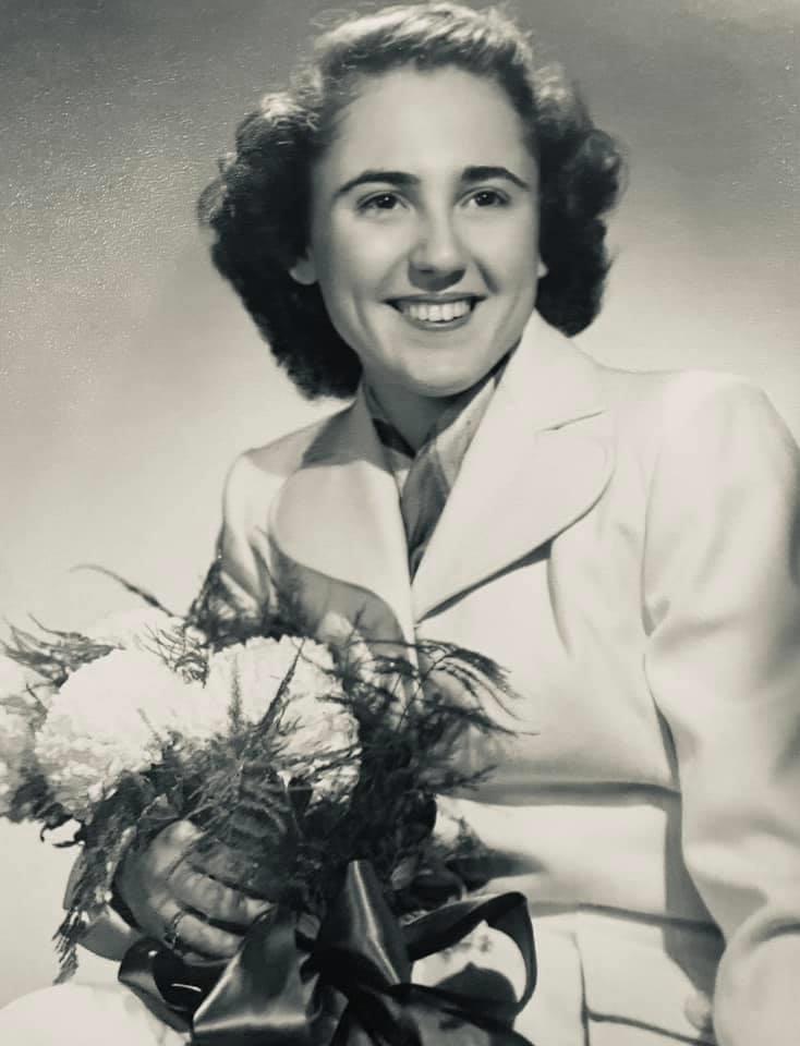 A woman holding flowers smiling
