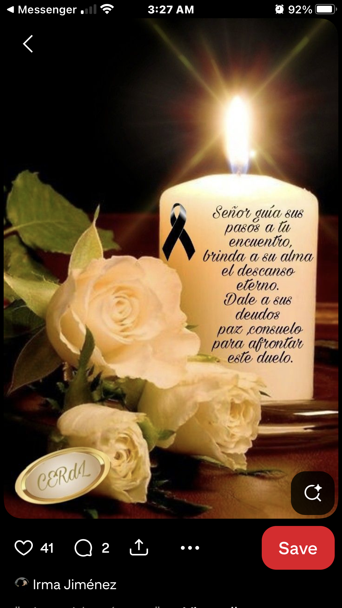 A candle and roses with a black ribbon