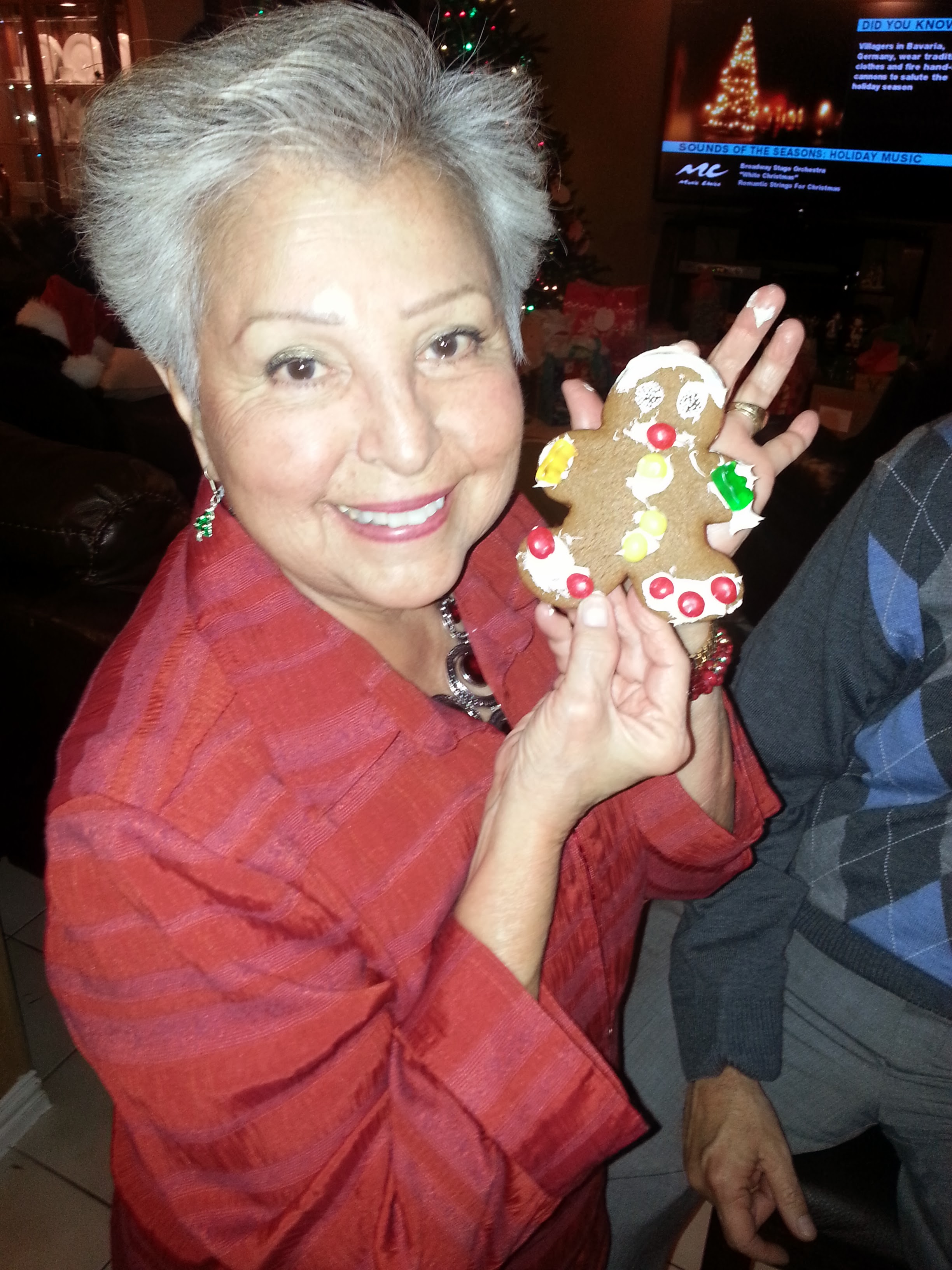 A woman holding a gingerbread man