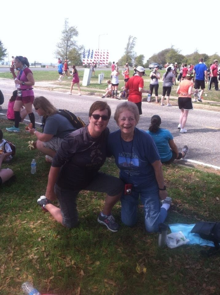 A man and woman kneeling on grass