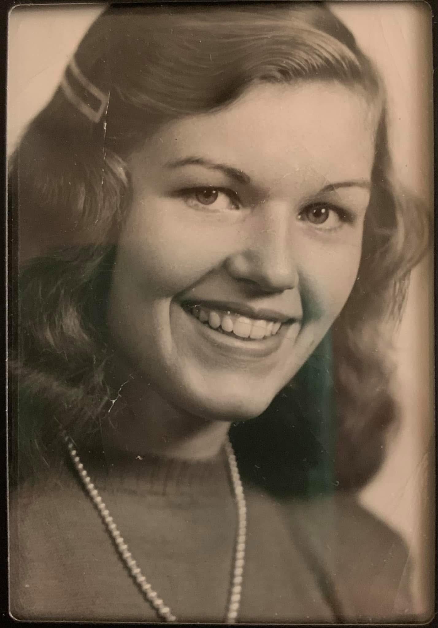 A woman smiling with a necklace
