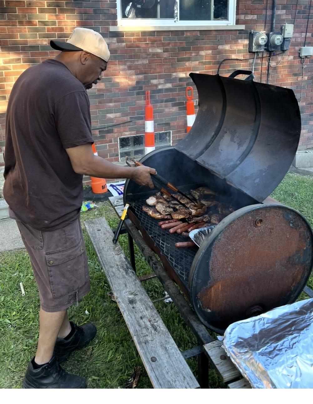 A man grilling meat on a grill