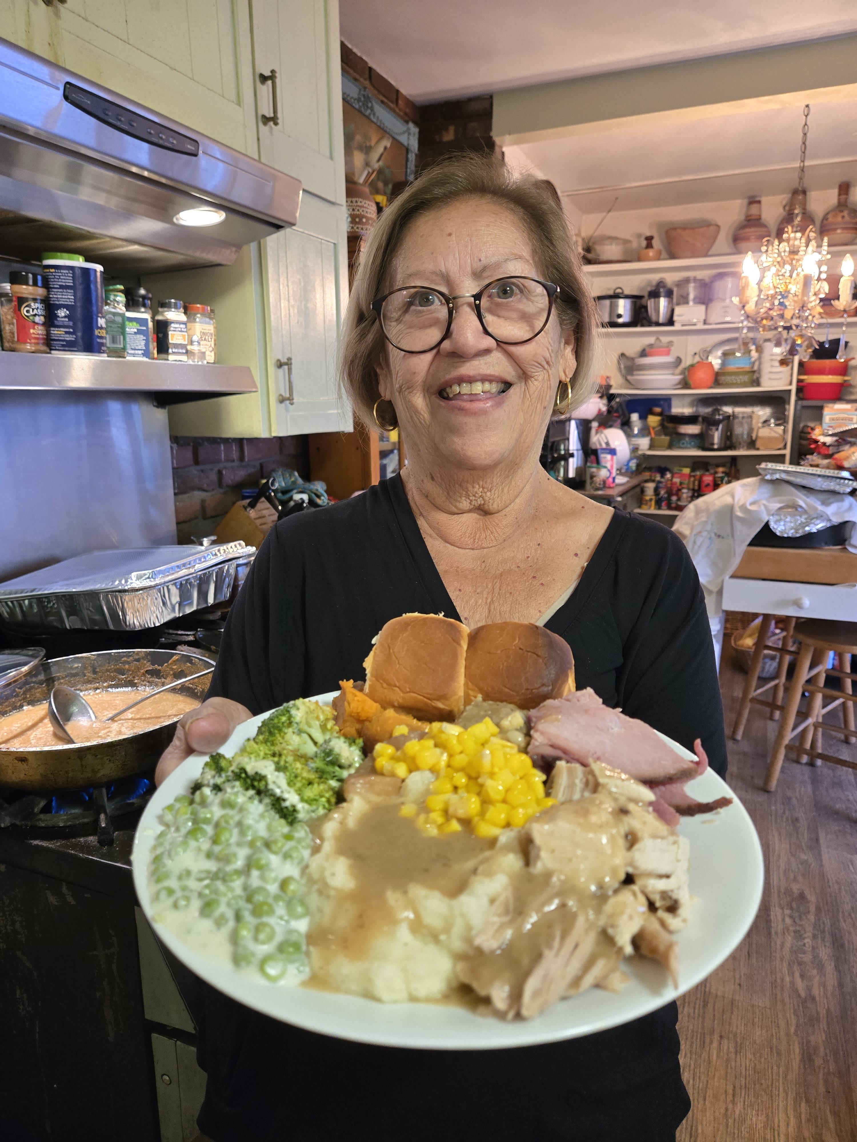 A woman holding a plate of food