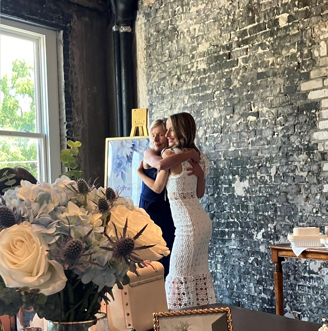 Two women hugging in a room